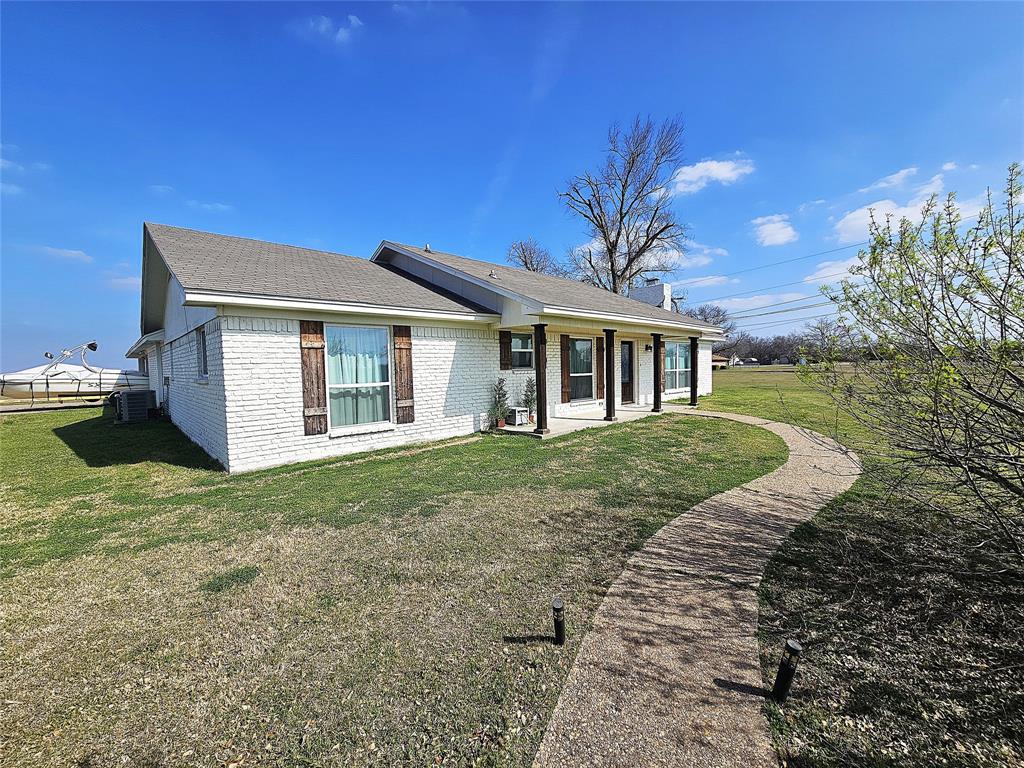 1205 West Trinity Street Groesbeck, TX 76642 - Photo 28 of 28 a front view of a house with a garden