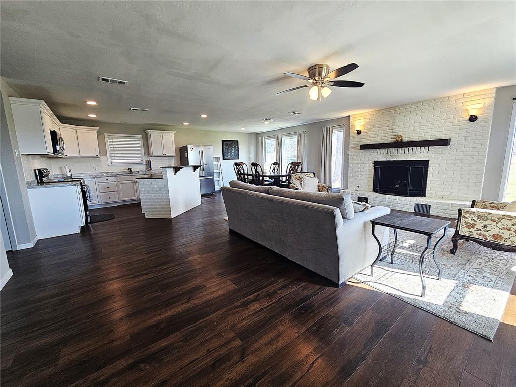 1205 West Trinity Street Groesbeck, TX 76642 - Photo 3 of 28 a living room with fireplace furniture and a flat screen tv