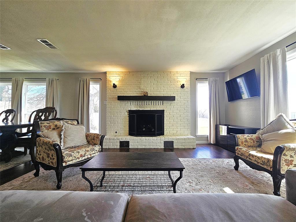 1205 West Trinity Street Groesbeck, TX 76642 - Photo 4 of 28 a living room with furniture and a fireplace
