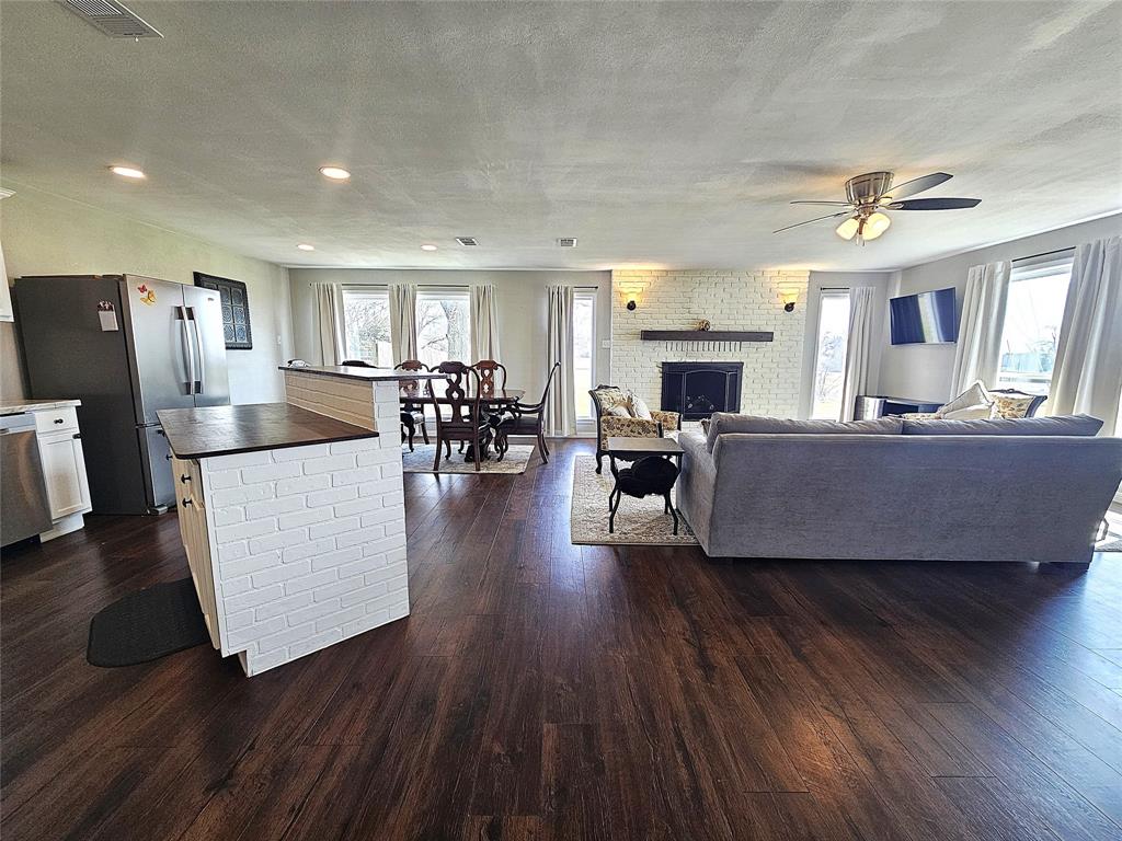 1205 West Trinity Street Groesbeck, TX 76642 - Photo 9 of 28 a living room with furniture and a fireplace