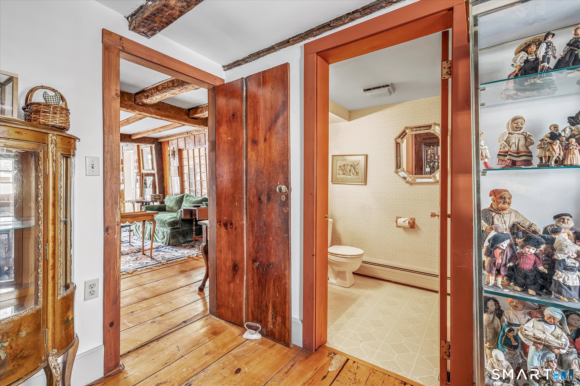 5695 Main Street Stratford, CT 06614 - Photo 18 of 40 a view of a hallway and a livingroom with wooden floor and furniture