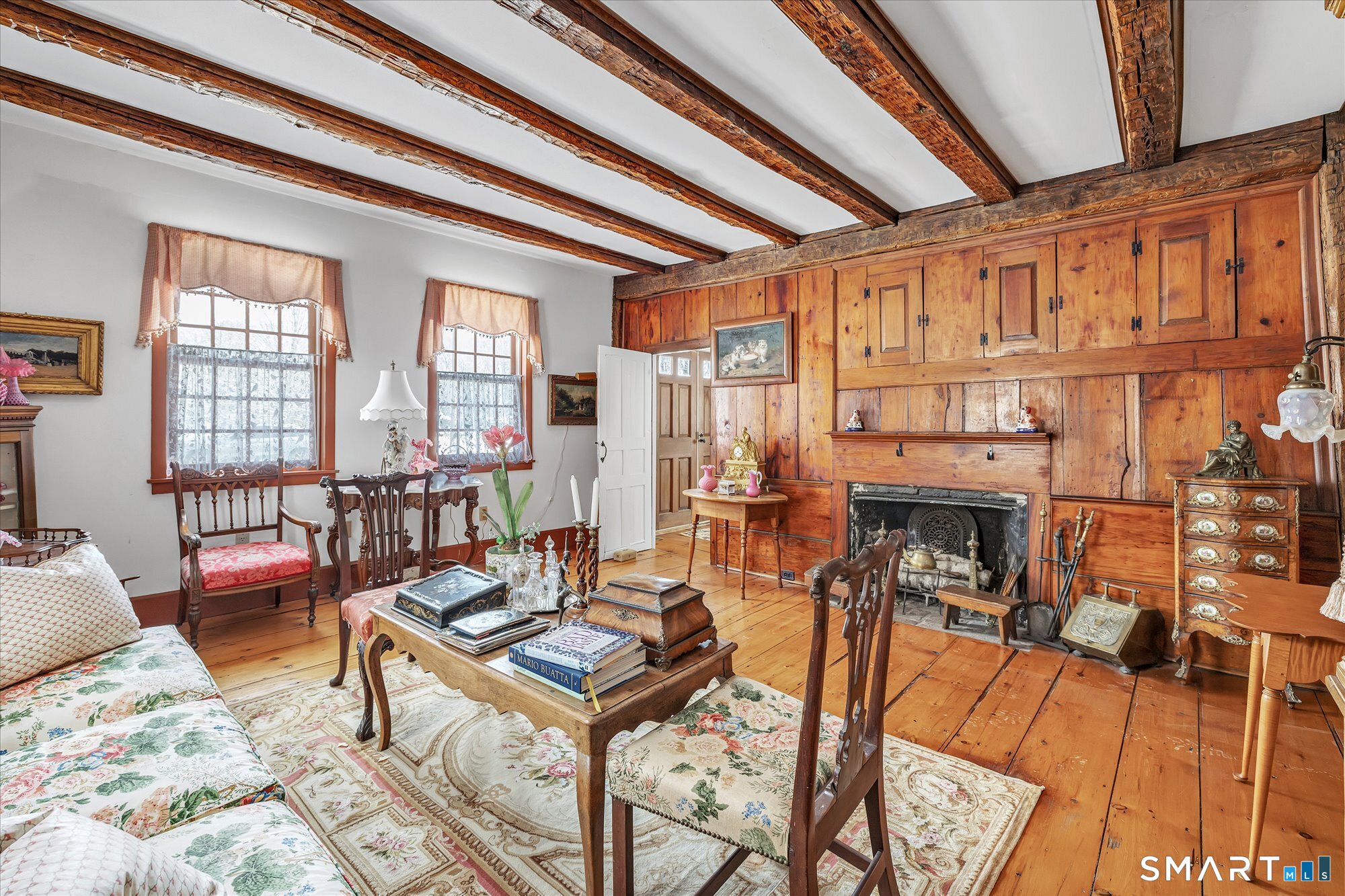 5695 Main Street Stratford, CT 06614 - Photo 21 of 40 a living room with furniture a fireplace and large windows