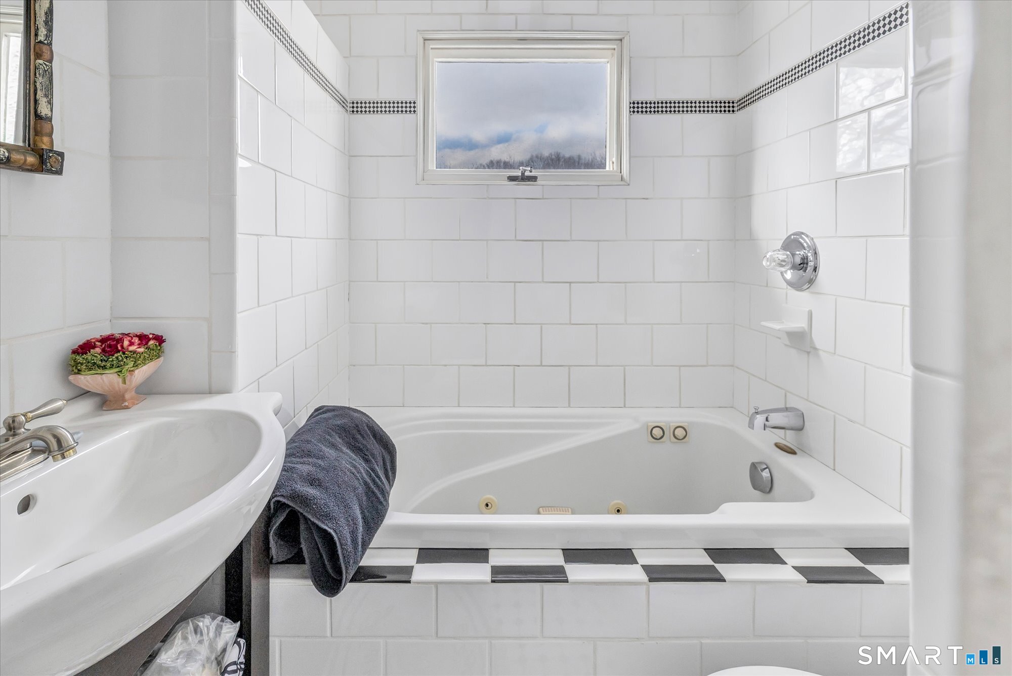 5695 Main Street Stratford, CT 06614 - Photo 39 of 40 a bathroom with a tub sink and a mirror