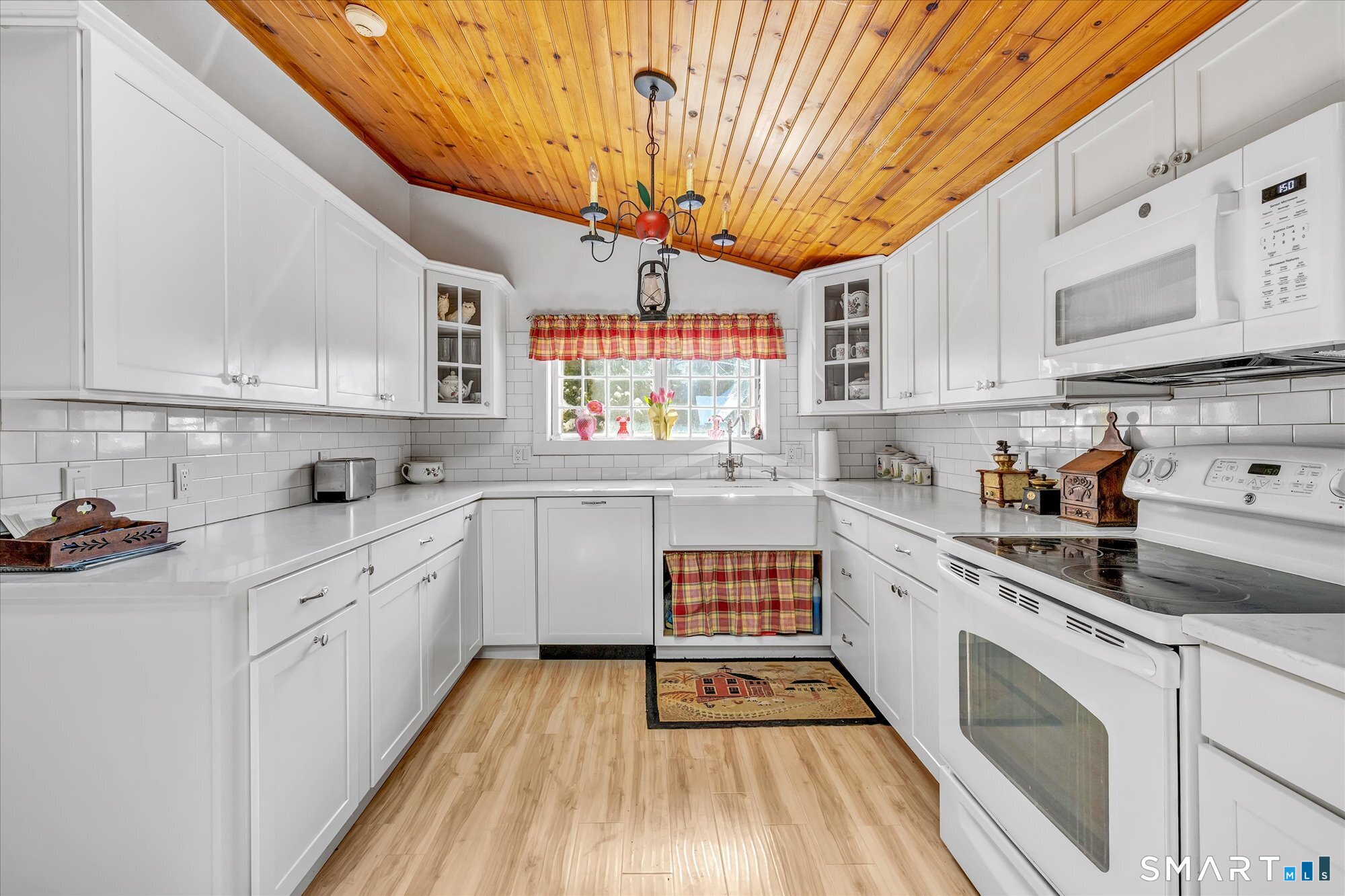 5695 Main Street Stratford, CT 06614 - Photo 8 of 40 a kitchen with stainless steel appliances a sink a stove top oven a counter space and cabinets