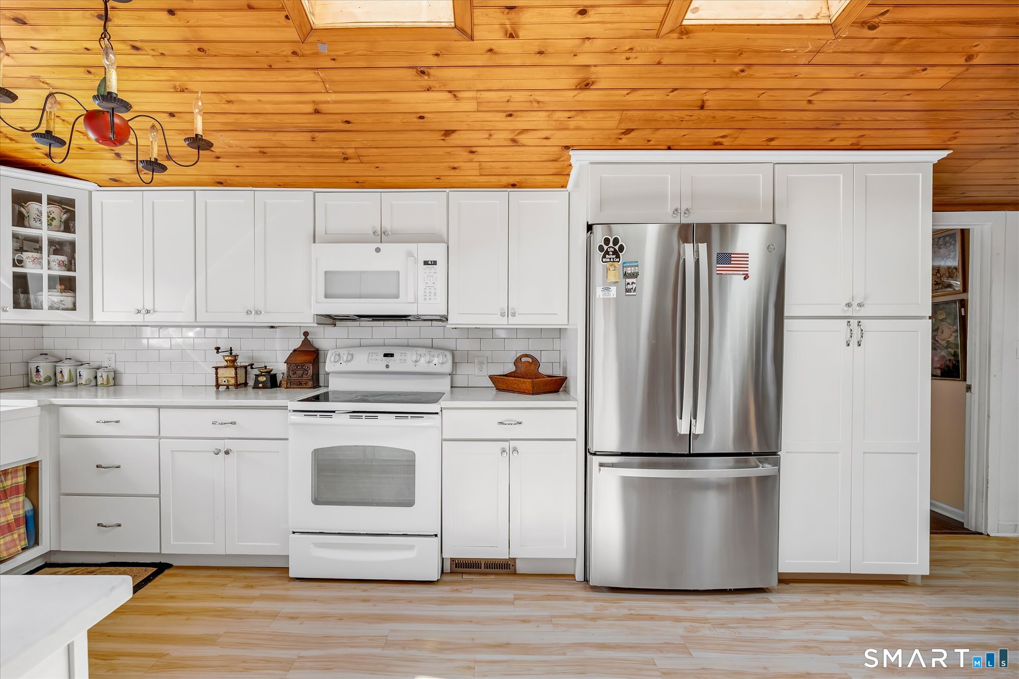 5695 Main Street Stratford, CT 06614 - Photo 9 of 40 a kitchen with stainless steel appliances white cabinets and wooden floor
