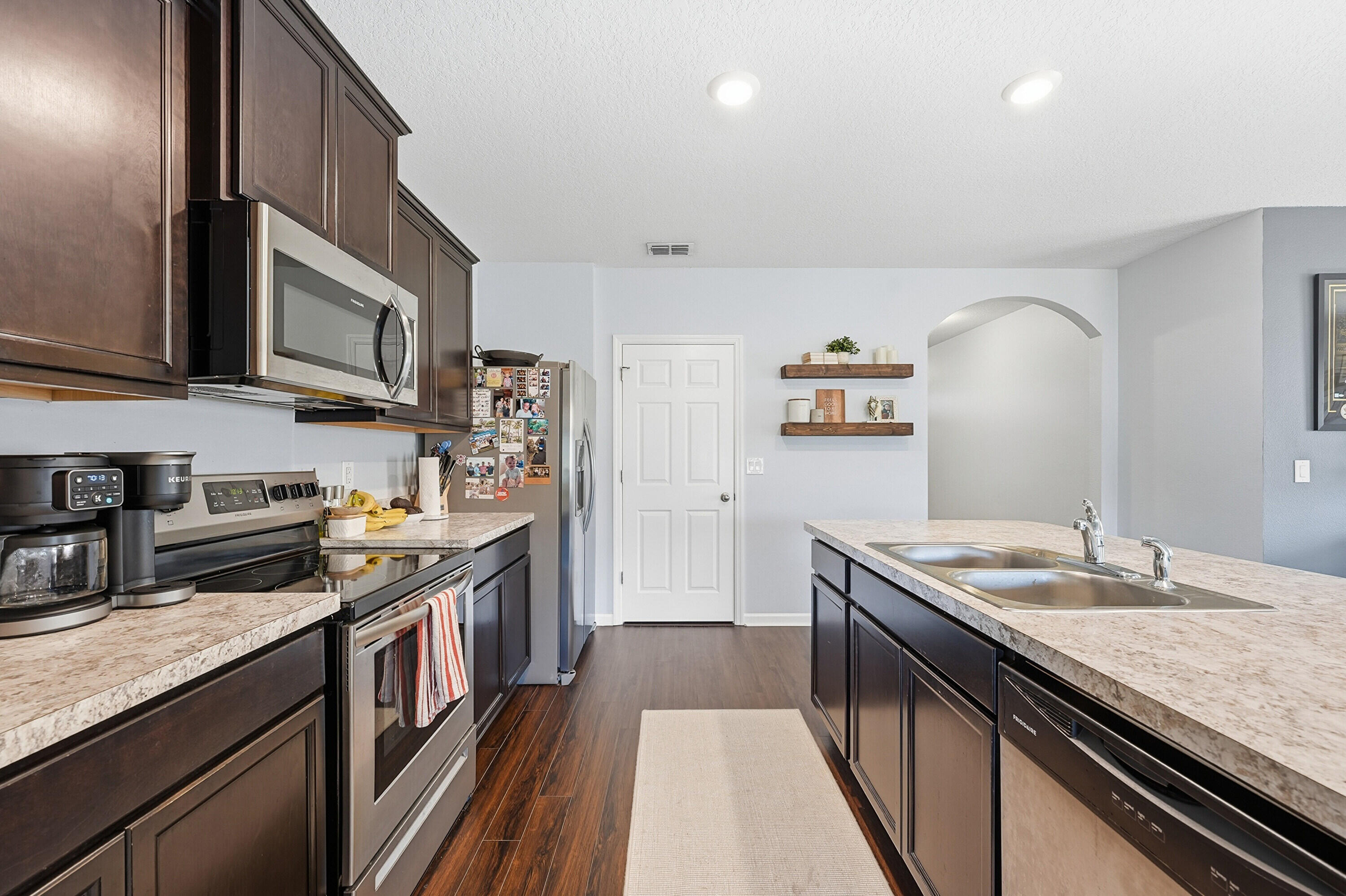 3113 Yellowstone Circle Fort Pierce, FL 34945 - Photo 11 of 33 a kitchen with stainless steel appliances granite countertop a sink stove and cabinets