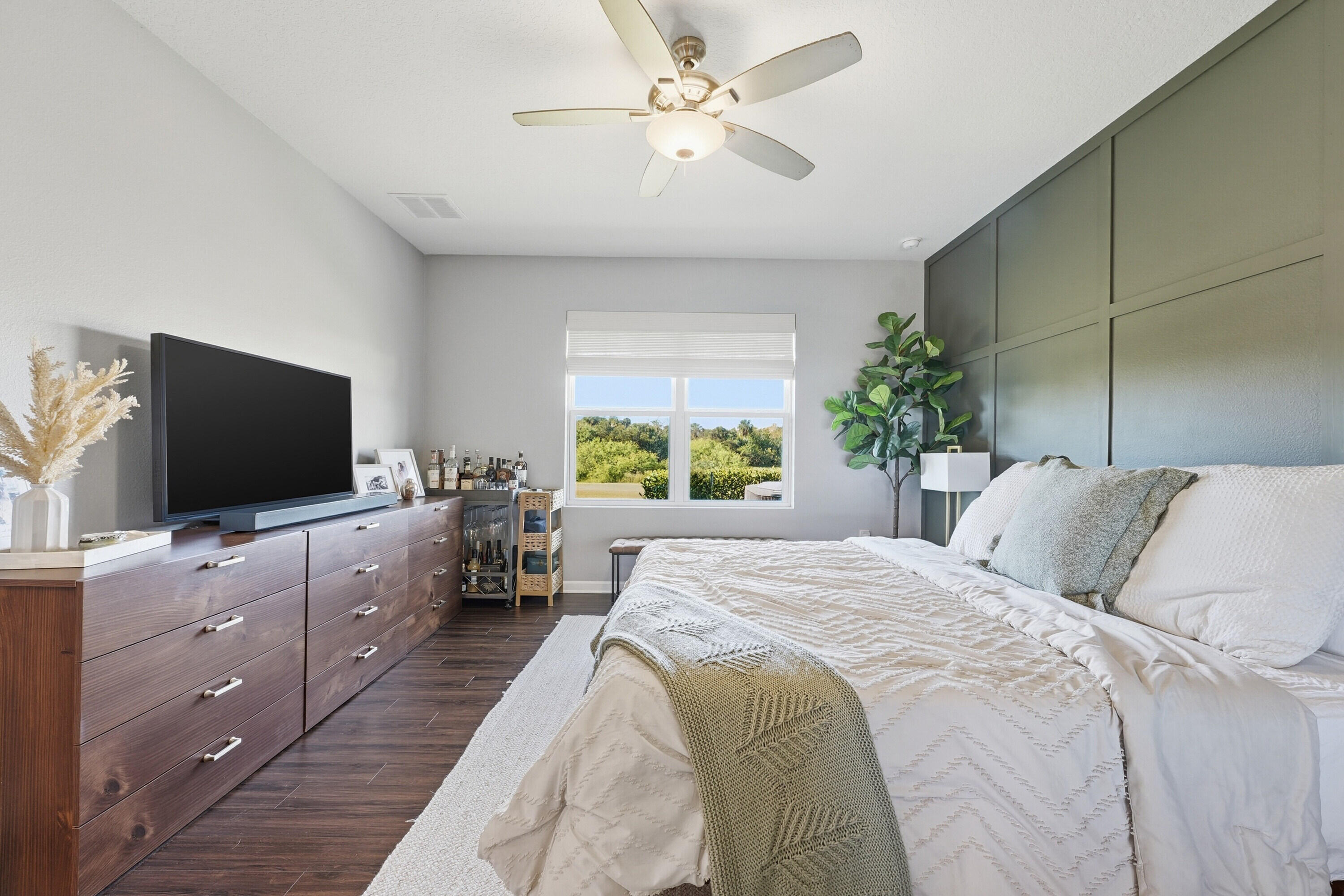 3113 Yellowstone Circle Fort Pierce, FL 34945 - Photo 14 of 33 a bedroom with a bed and a flat screen tv on the dresser