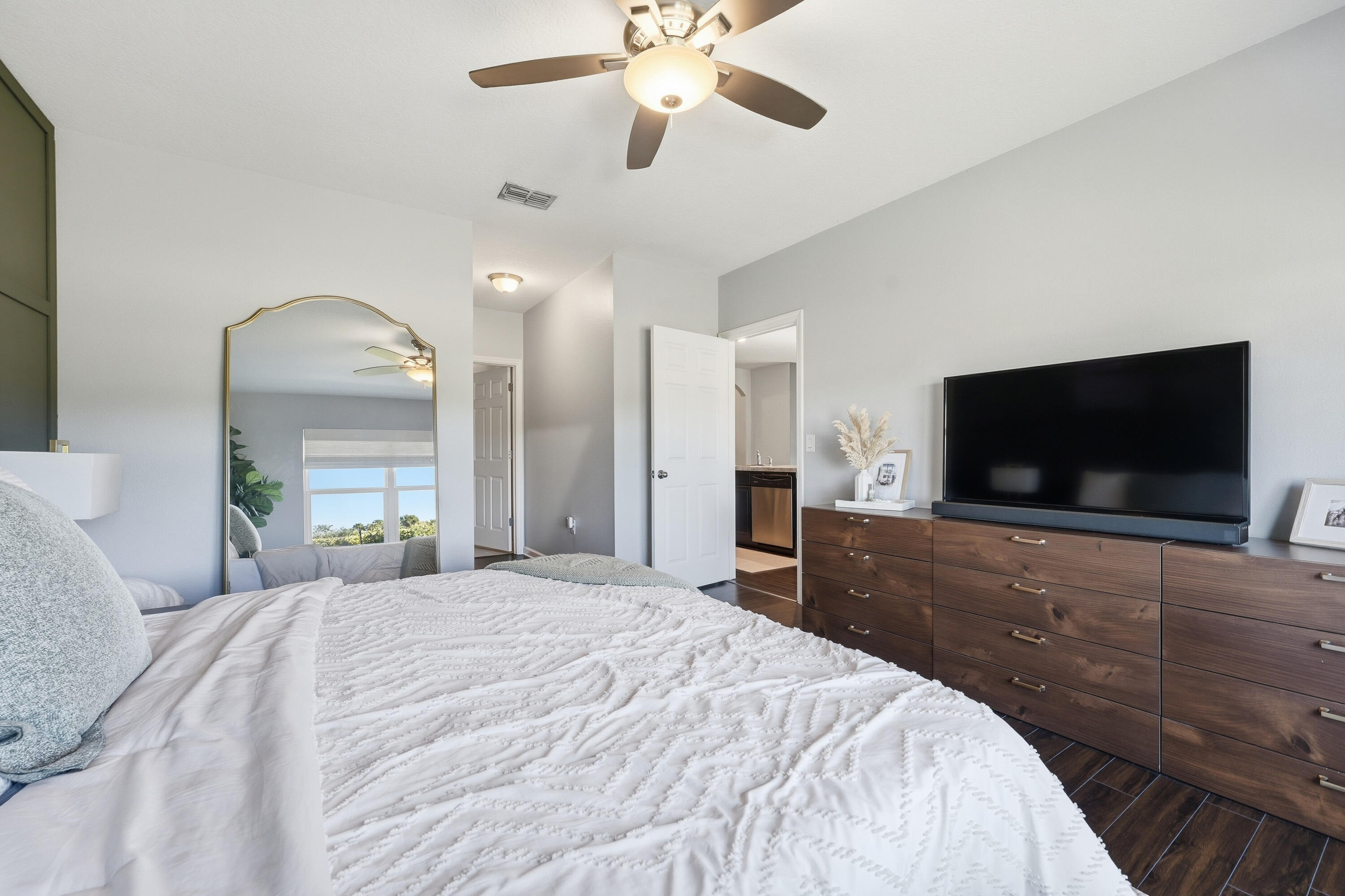 3113 Yellowstone Circle Fort Pierce, FL 34945 - Photo 15 of 33 a bedroom with a bed and a flat screen tv