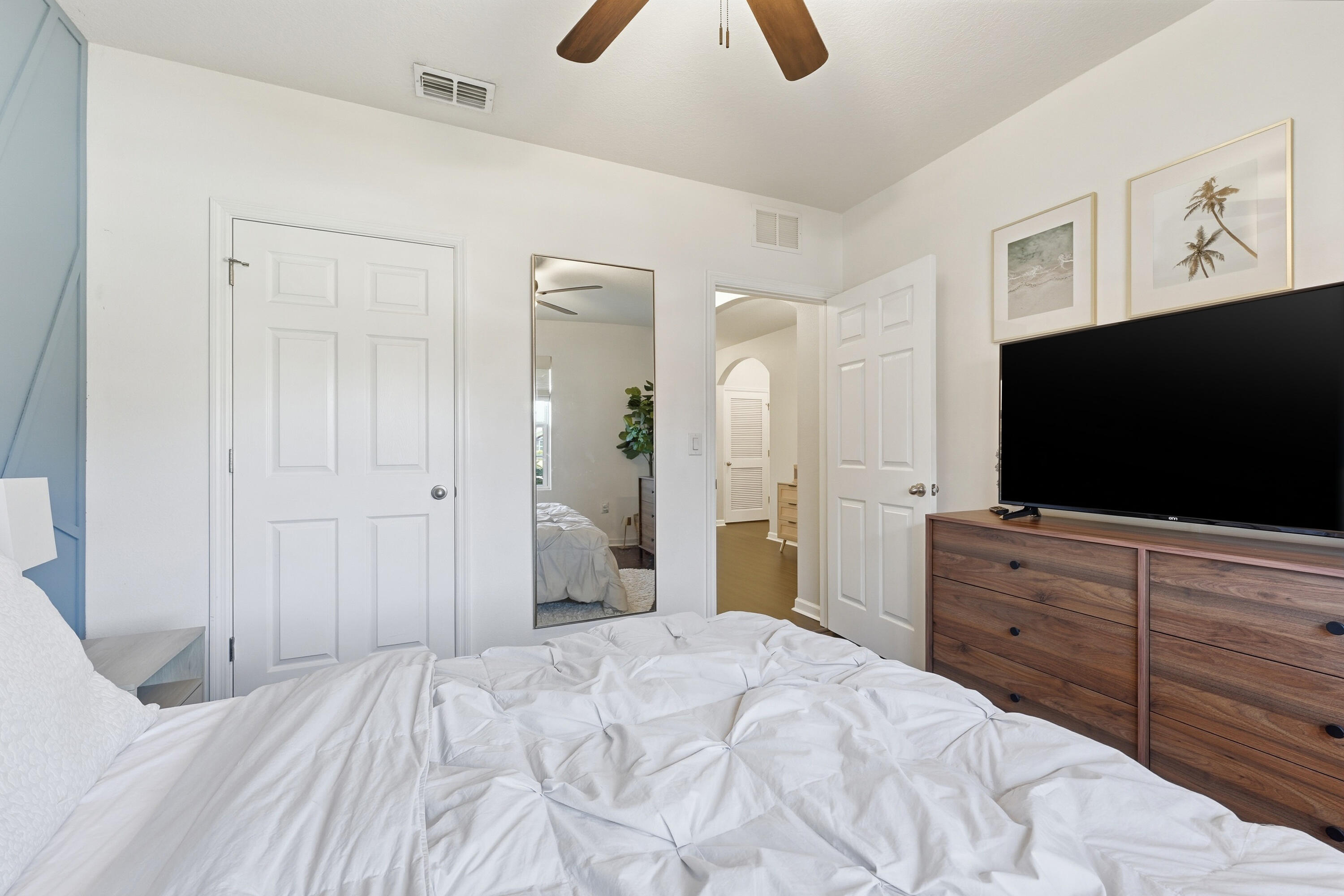 3113 Yellowstone Circle Fort Pierce, FL 34945 - Photo 18 of 33 a bedroom with a bed and a flat screen tv in white walls