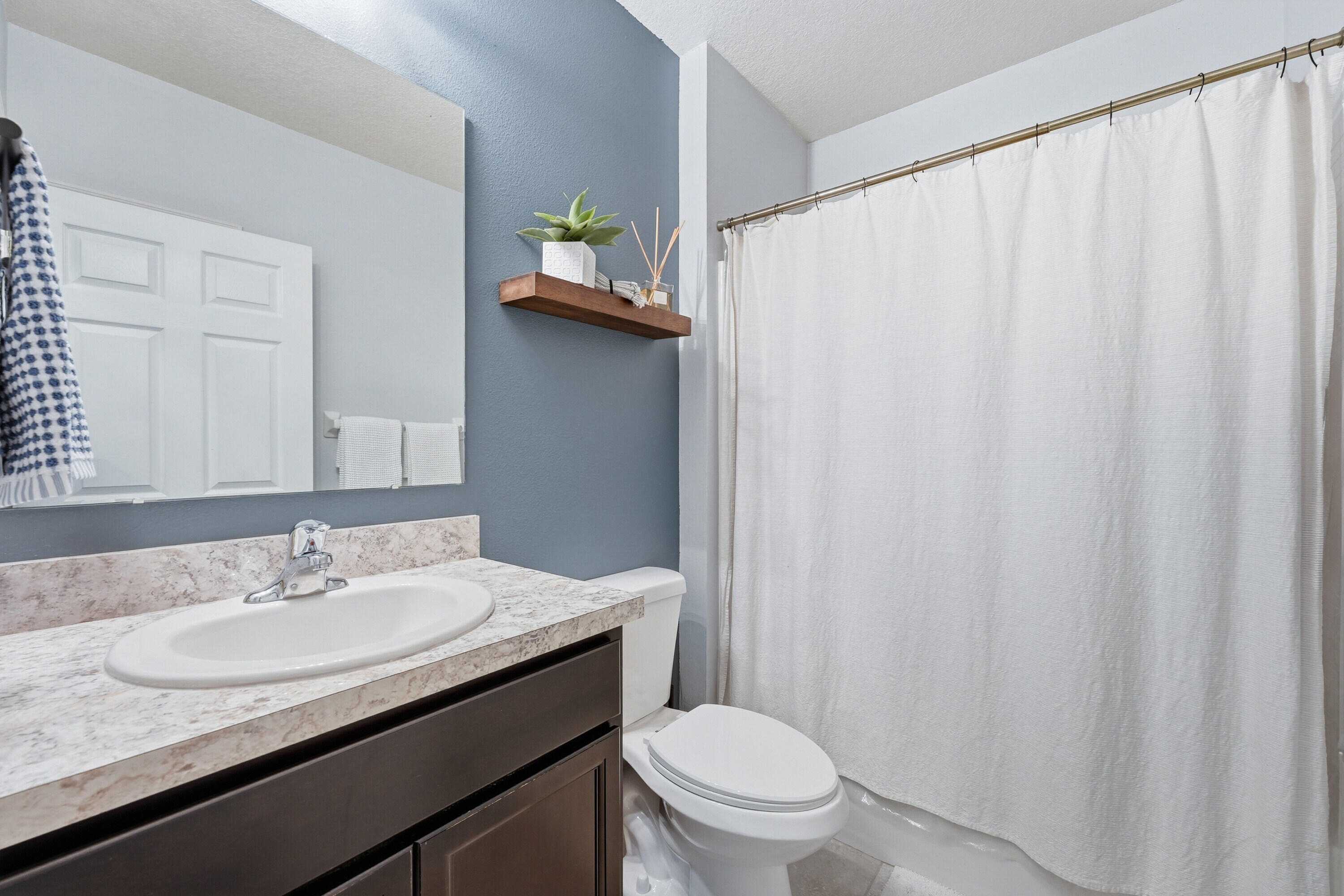 3113 Yellowstone Circle Fort Pierce, FL 34945 - Photo 21 of 33 a bathroom with a granite countertop sink and a mirror