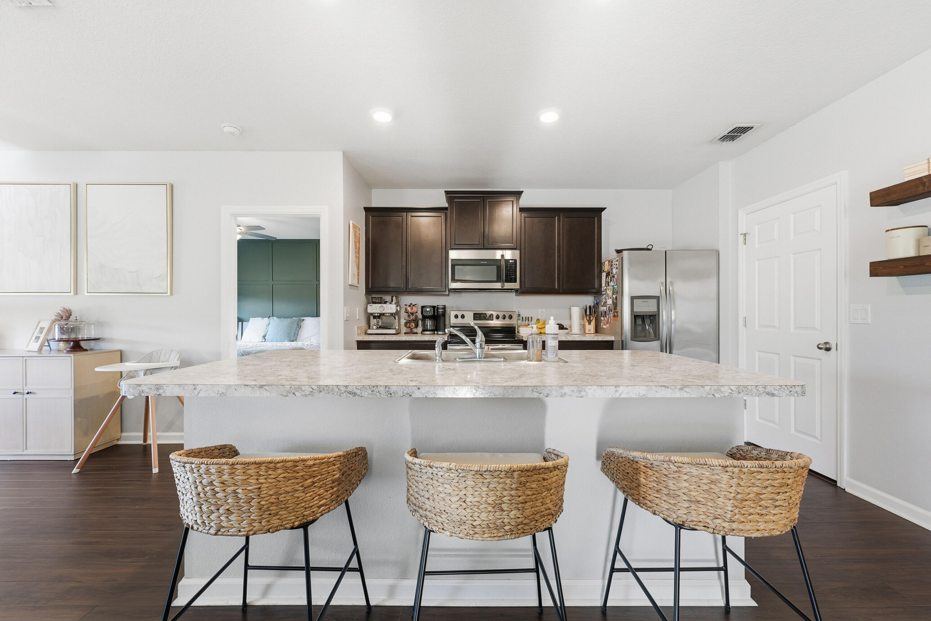 3113 Yellowstone Circle Fort Pierce, FL 34945 - Photo 9 of 33 a kitchen with stainless steel appliances granite countertop a stove top oven a sink a dining table and chairs
