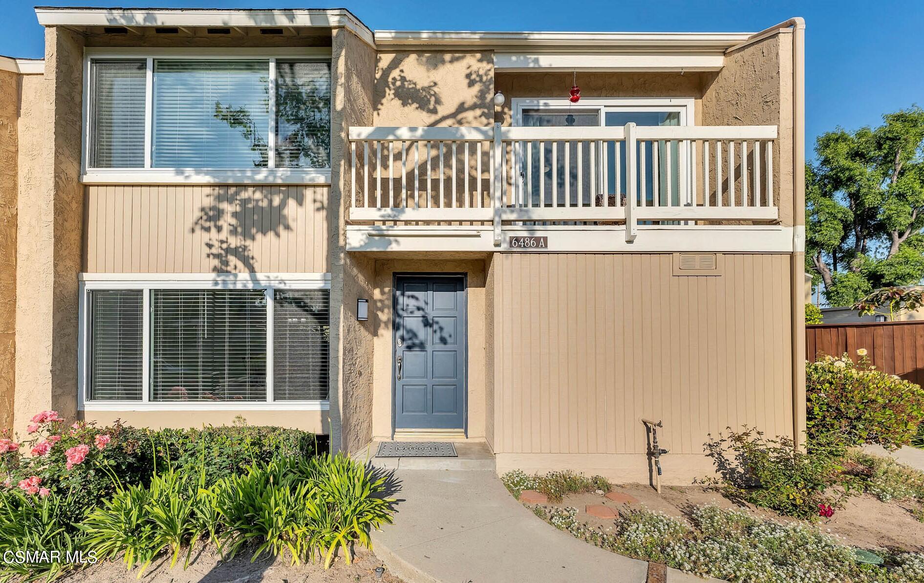 a view of a house with a small yard and plants