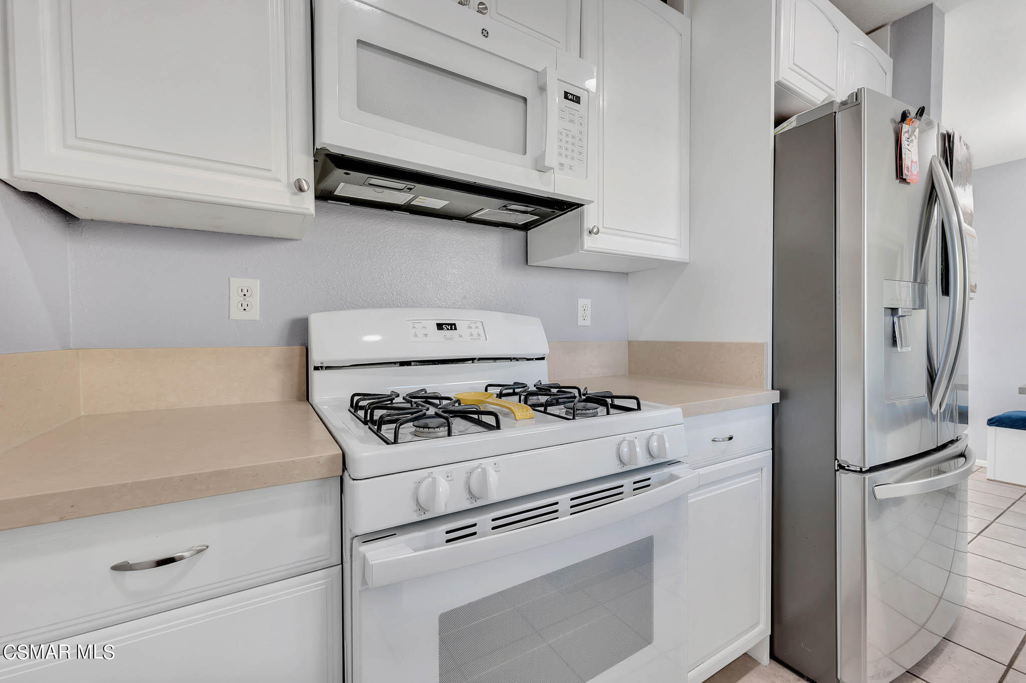 6486 Penn Street, Unit A Moorpark, CA 93021 - Photo 11 of 35 a kitchen with stainless steel appliances white cabinets and a stove