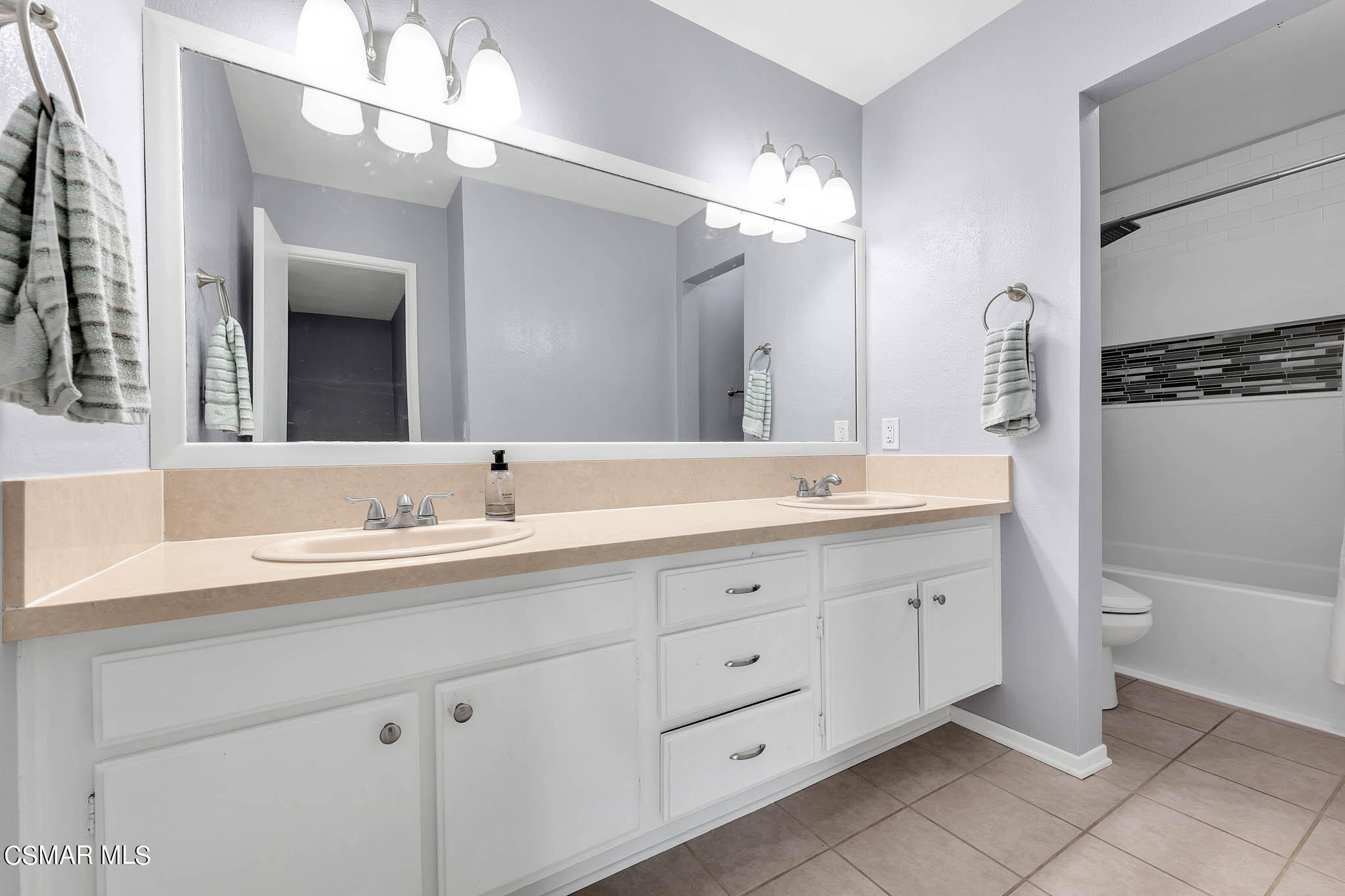6486 Penn Street, Unit A Moorpark, CA 93021 - Photo 18 of 35 a bathroom with a granite countertop sink mirror and toilet