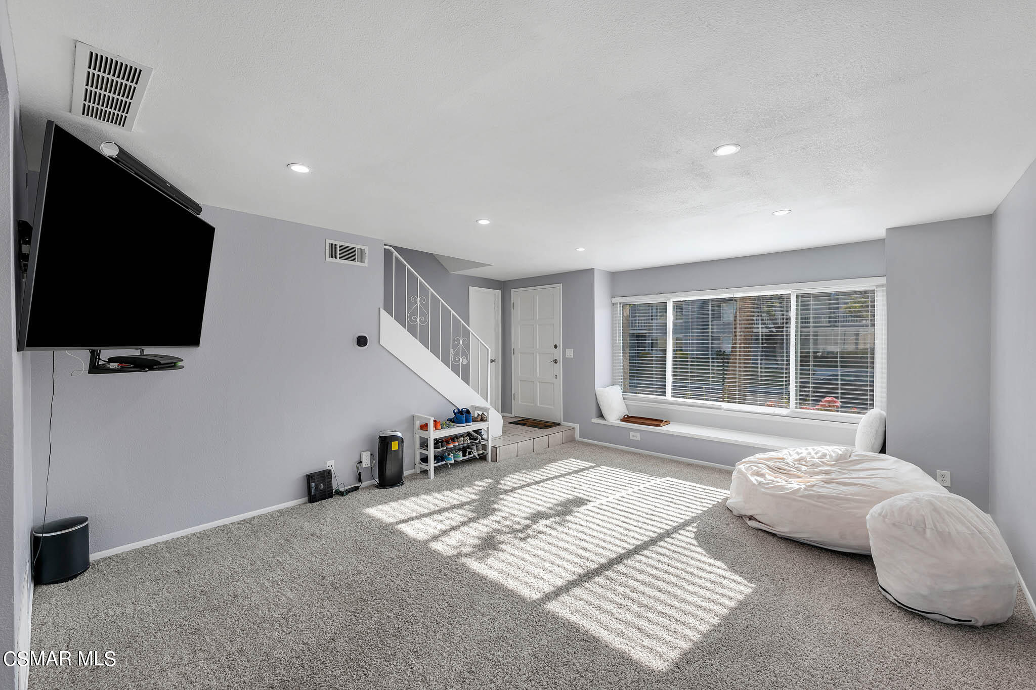 6486 Penn Street, Unit A Moorpark, CA 93021 - Photo 2 of 35 a spacious bedroom with a bed and a flat screen tv