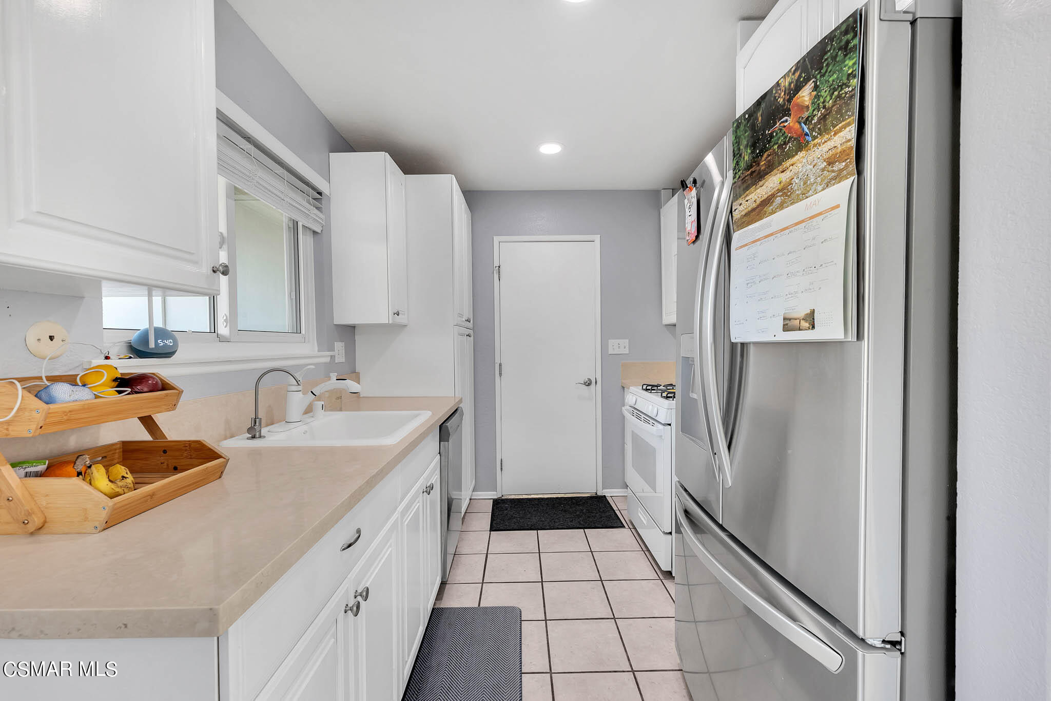 6486 Penn Street, Unit A Moorpark, CA 93021 - Photo 10 of 35 a kitchen with a sink a refrigerator and cabinets