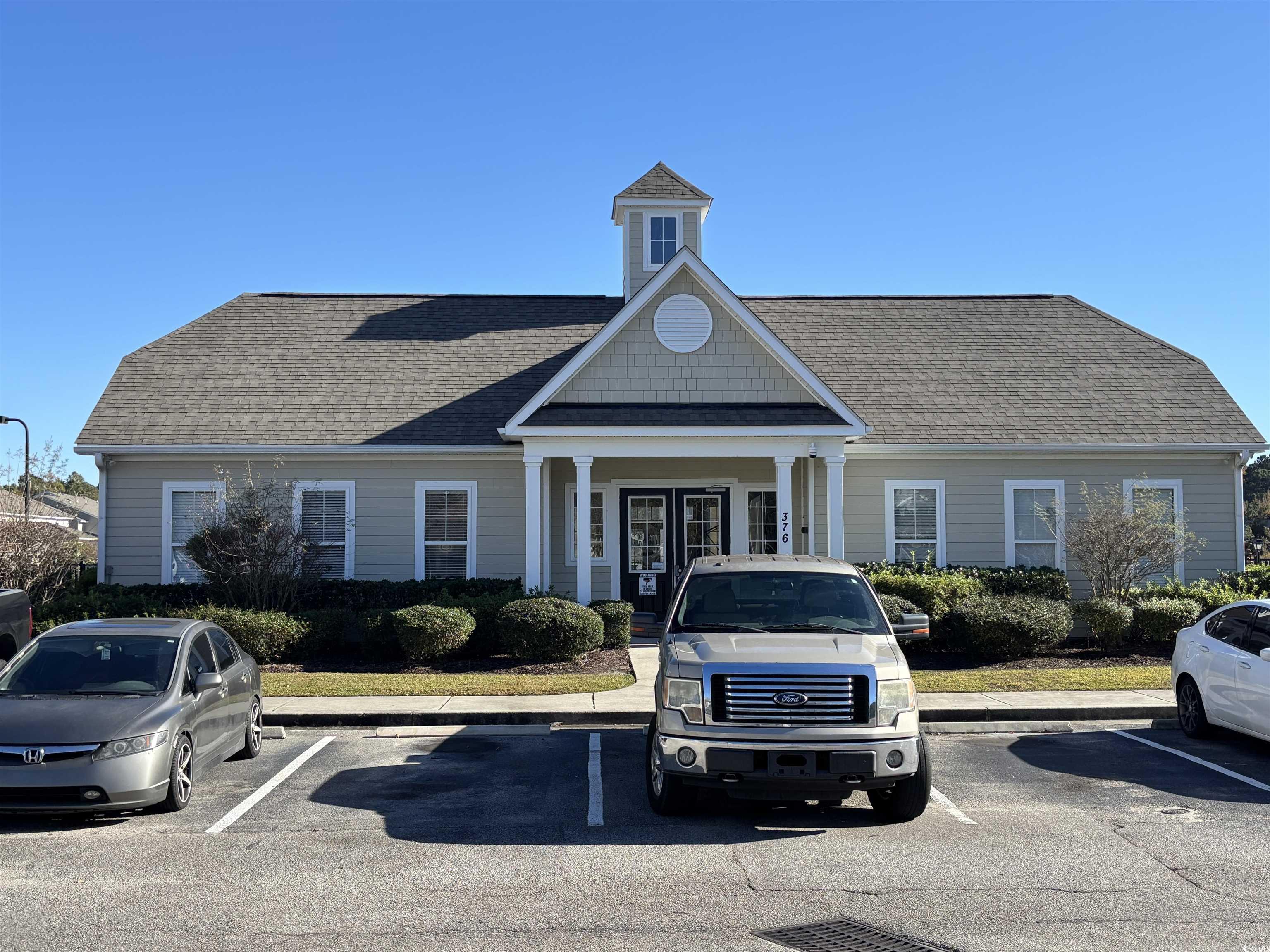 328 Kiskadee Loop, Unit 15C Conway, SC 29526 - Photo 18 of 18 View of building exterior with uncovered parking