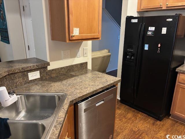 328 Kiskadee Loop, Unit 15C Conway, SC 29526 - Photo 3 of 18 Kitchen with black refrigerator with ice dispenser, dark countertops, dark wood-style flooring, stainless steel dishwasher, and brown cabinets