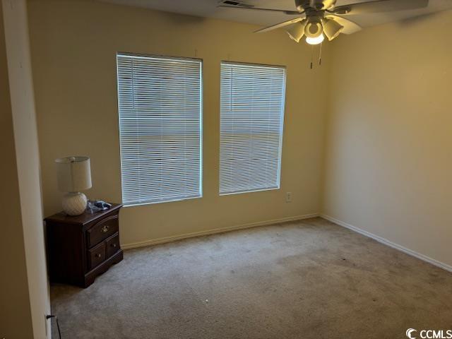 328 Kiskadee Loop, Unit 15C Conway, SC 29526 - Photo 7 of 18 Unfurnished room with light carpet and a ceiling fan