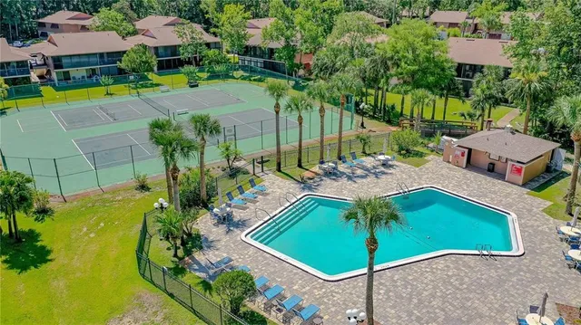 an aerial view of a house with swimming pool and patio