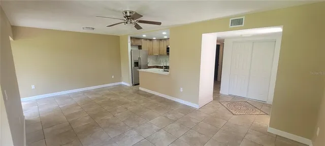 a view of a kitchen with a sink and a refrigerator