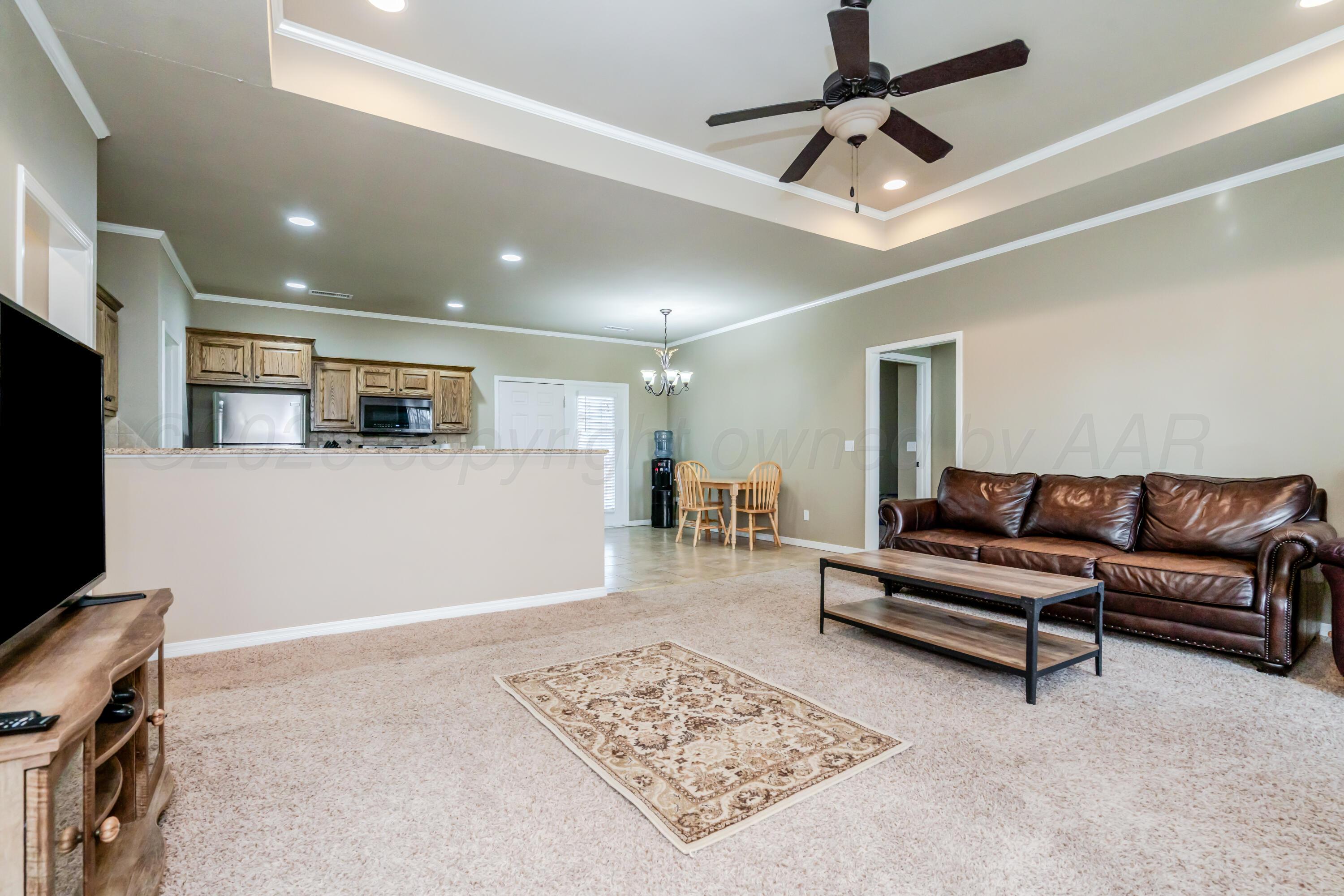 6814 Tivis Street Amarillo, TX 79119 - Photo 1 of 37 a living room with furniture and a flat screen tv