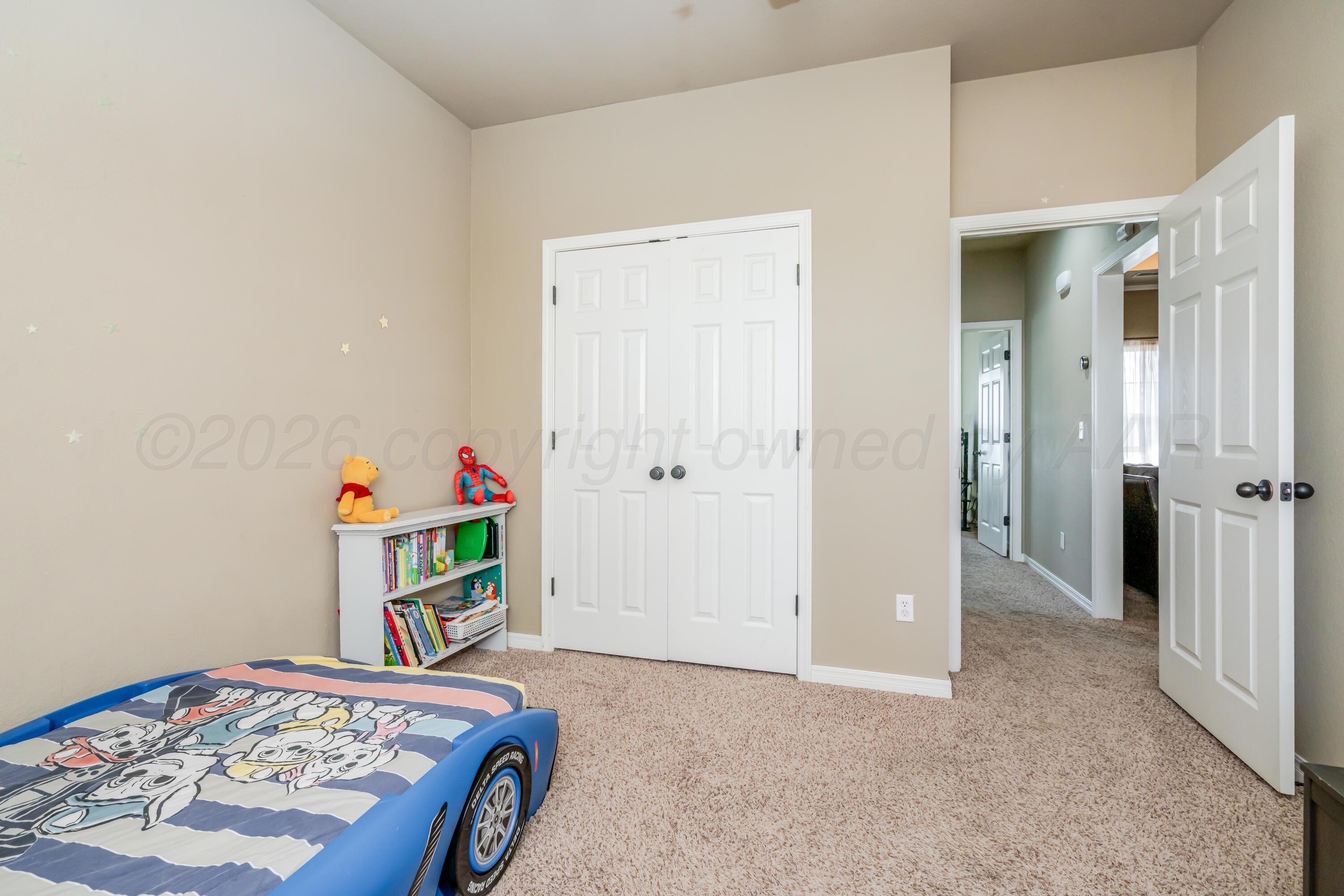 6814 Tivis Street Amarillo, TX 79119 - Photo 15 of 37 a bedroom with bed and a book shelf