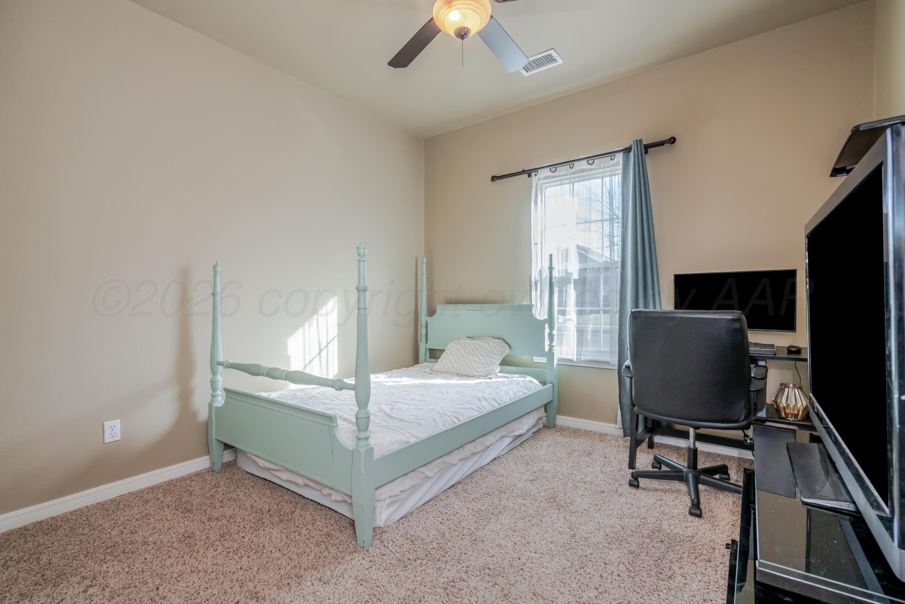 6814 Tivis Street Amarillo, TX 79119 - Photo 19 of 37 a bedroom with bed tv and window