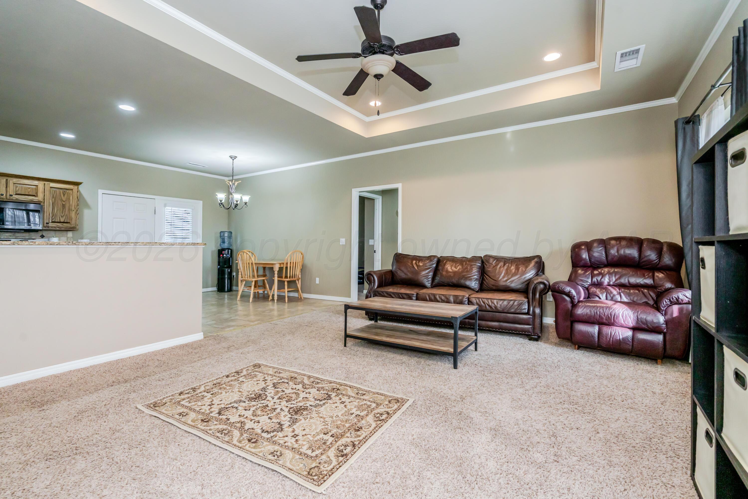 6814 Tivis Street Amarillo, TX 79119 - Photo 2 of 37 a living room with furniture and a rug