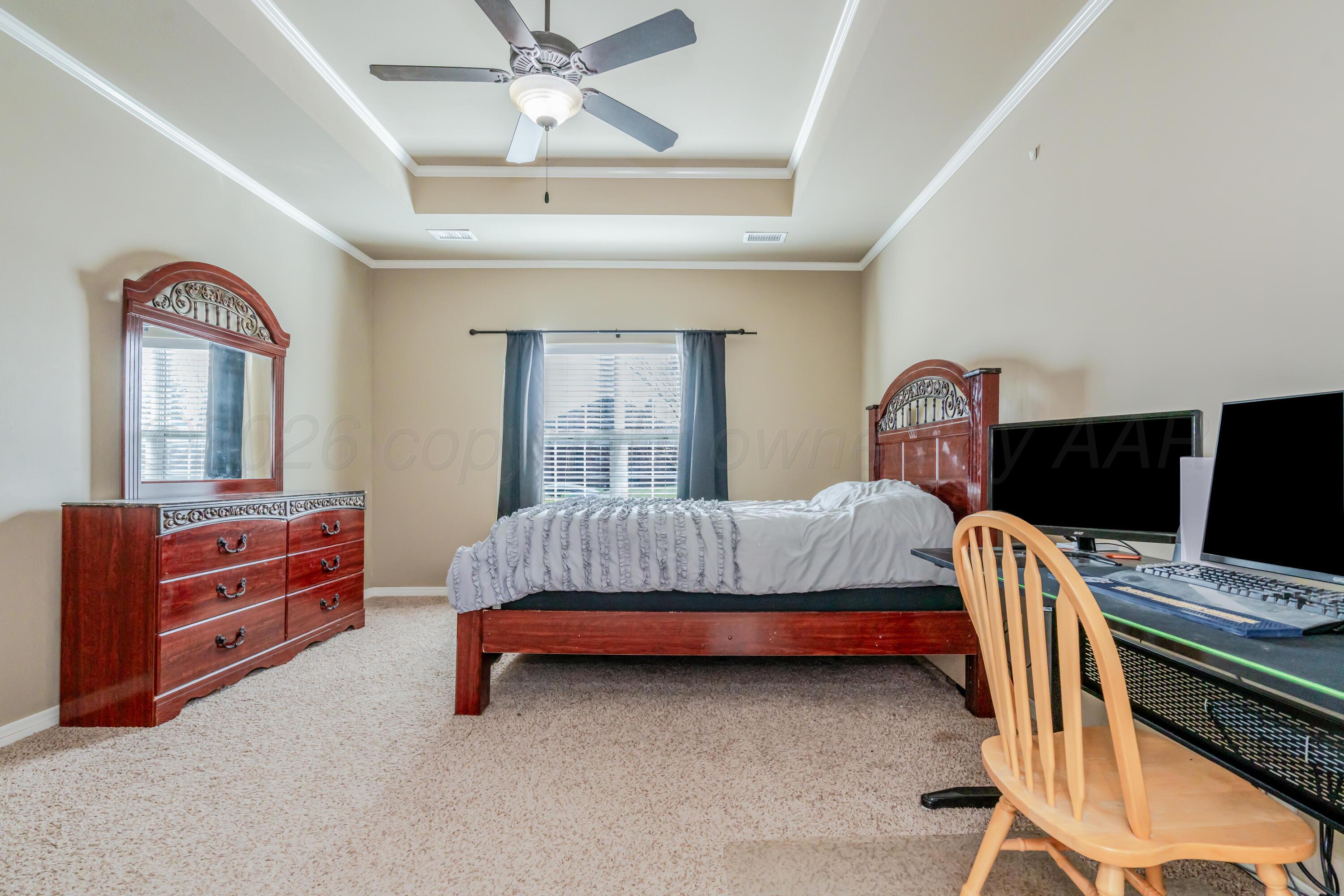 6814 Tivis Street Amarillo, TX 79119 - Photo 23 of 37 a bedroom with bed and wooden floor