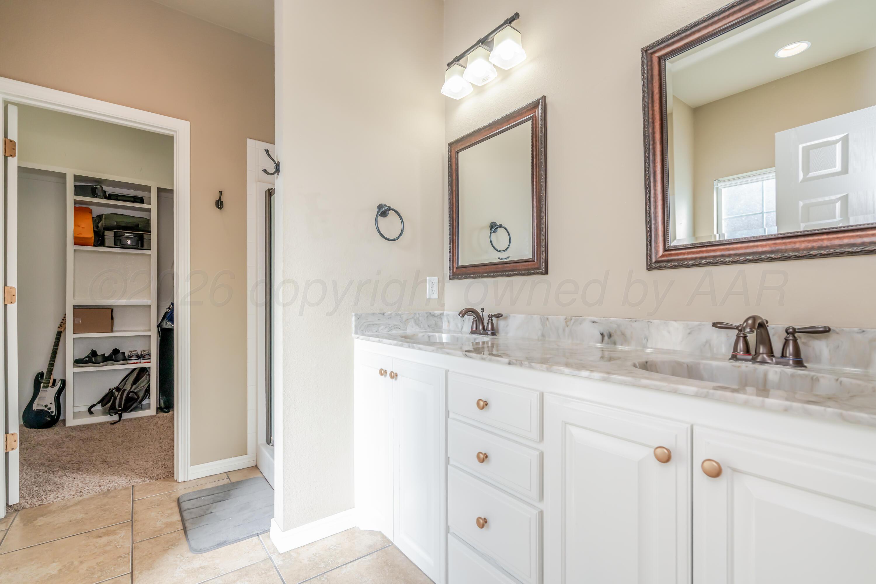 6814 Tivis Street Amarillo, TX 79119 - Photo 25 of 37 a bathroom with a sink and a mirror