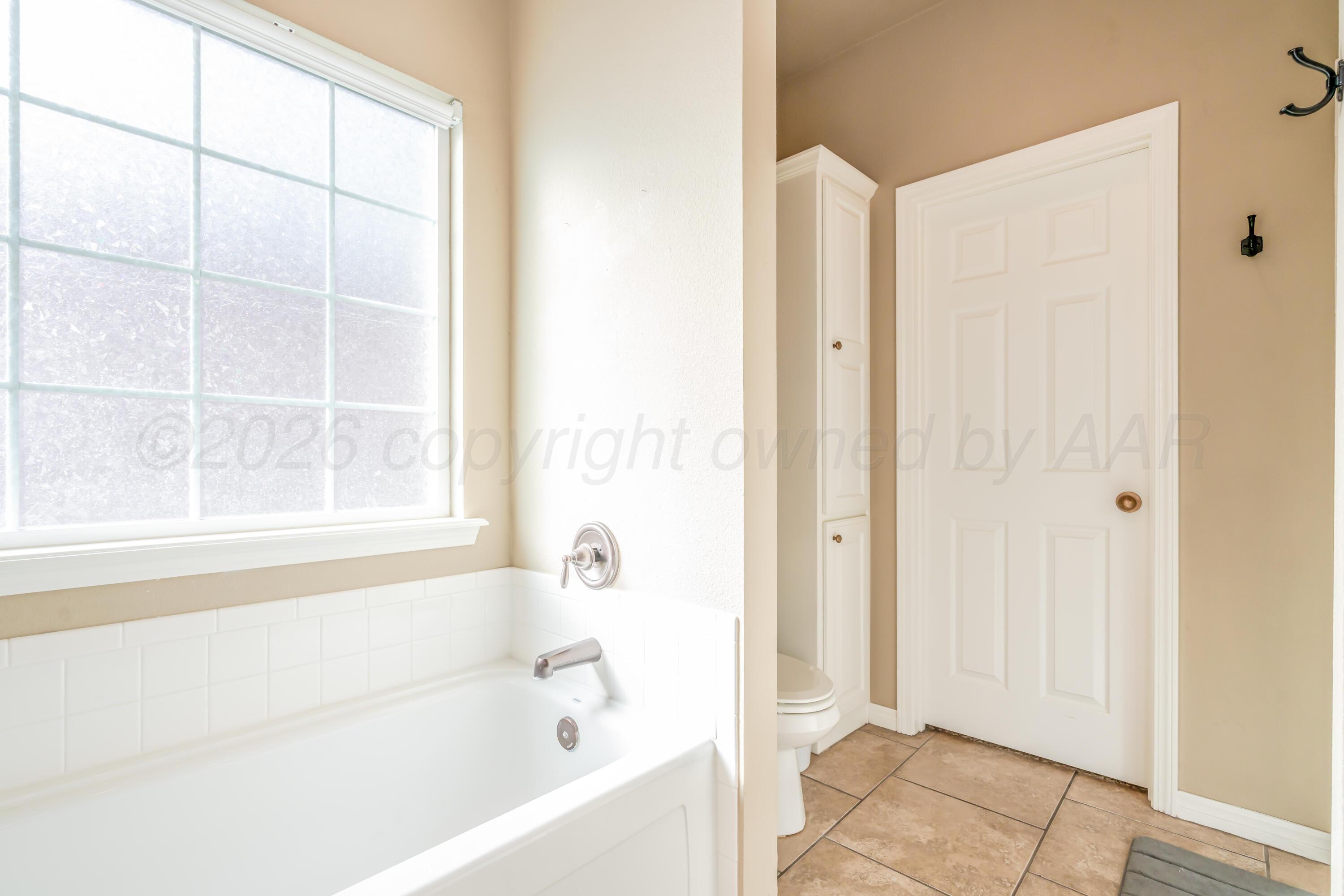 6814 Tivis Street Amarillo, TX 79119 - Photo 27 of 37 a bathroom with a bathtub and a shower