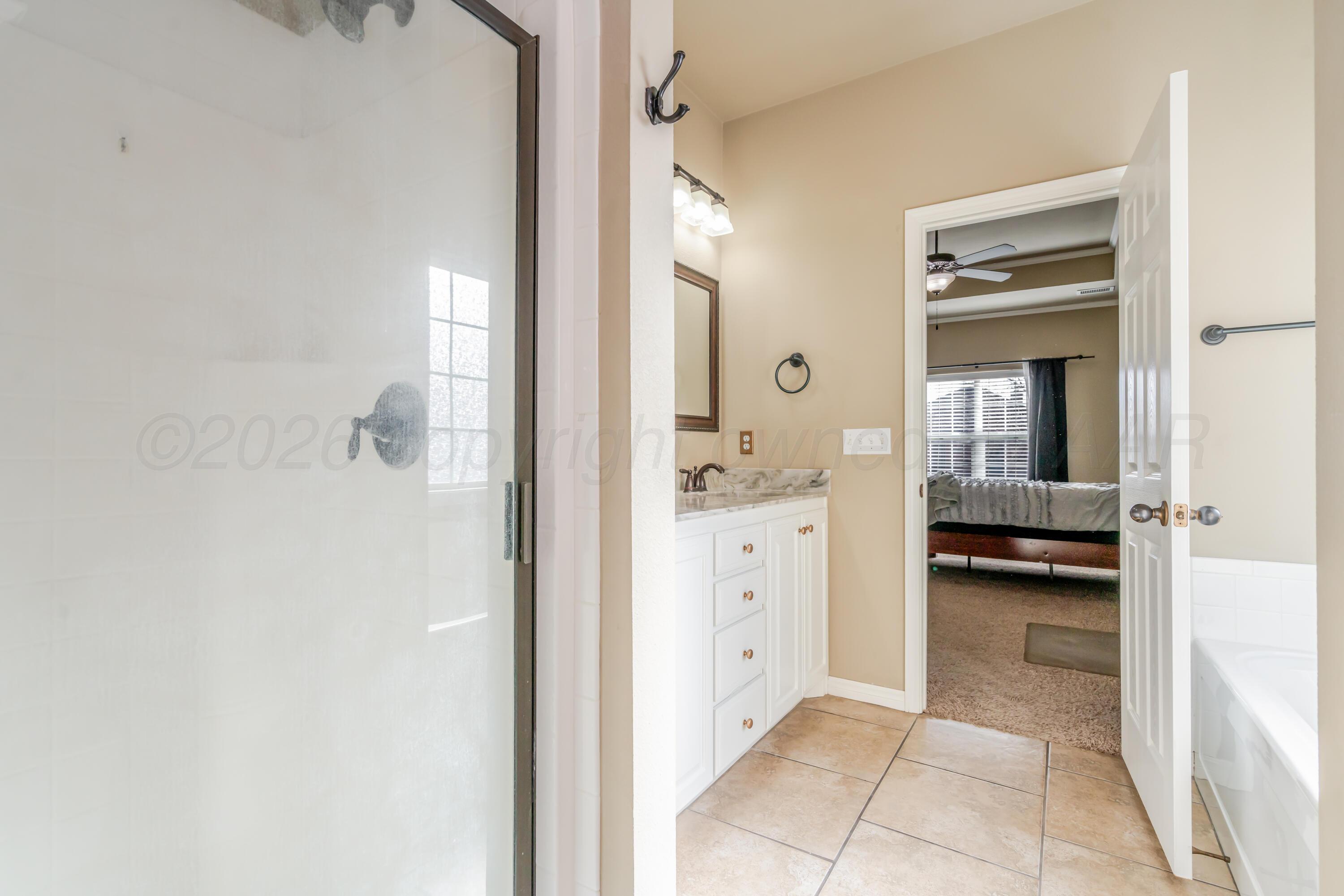 6814 Tivis Street Amarillo, TX 79119 - Photo 28 of 37 a bathroom with a sink and a mirror