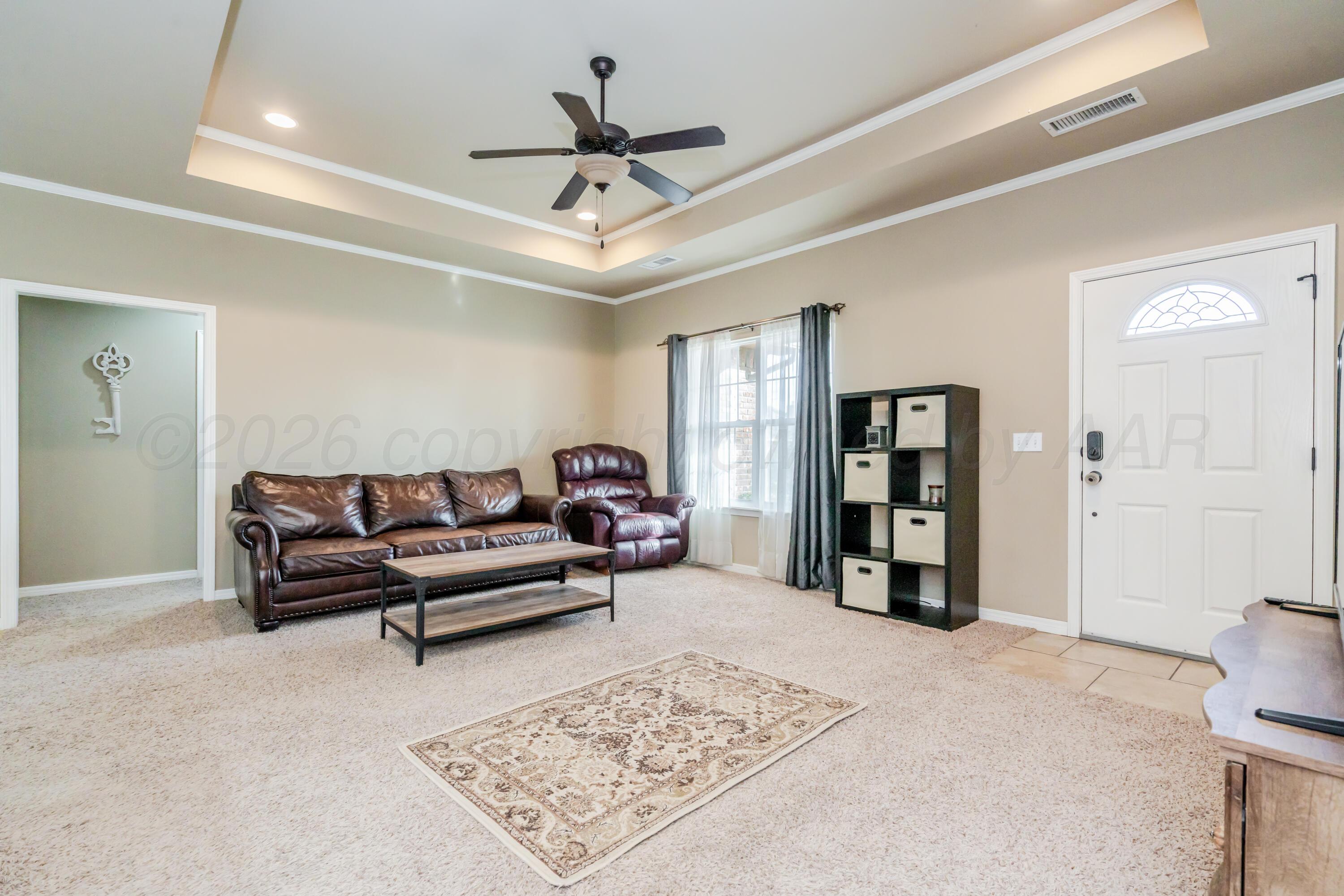 6814 Tivis Street Amarillo, TX 79119 - Photo 3 of 37 a living room with furniture and a ceiling fan