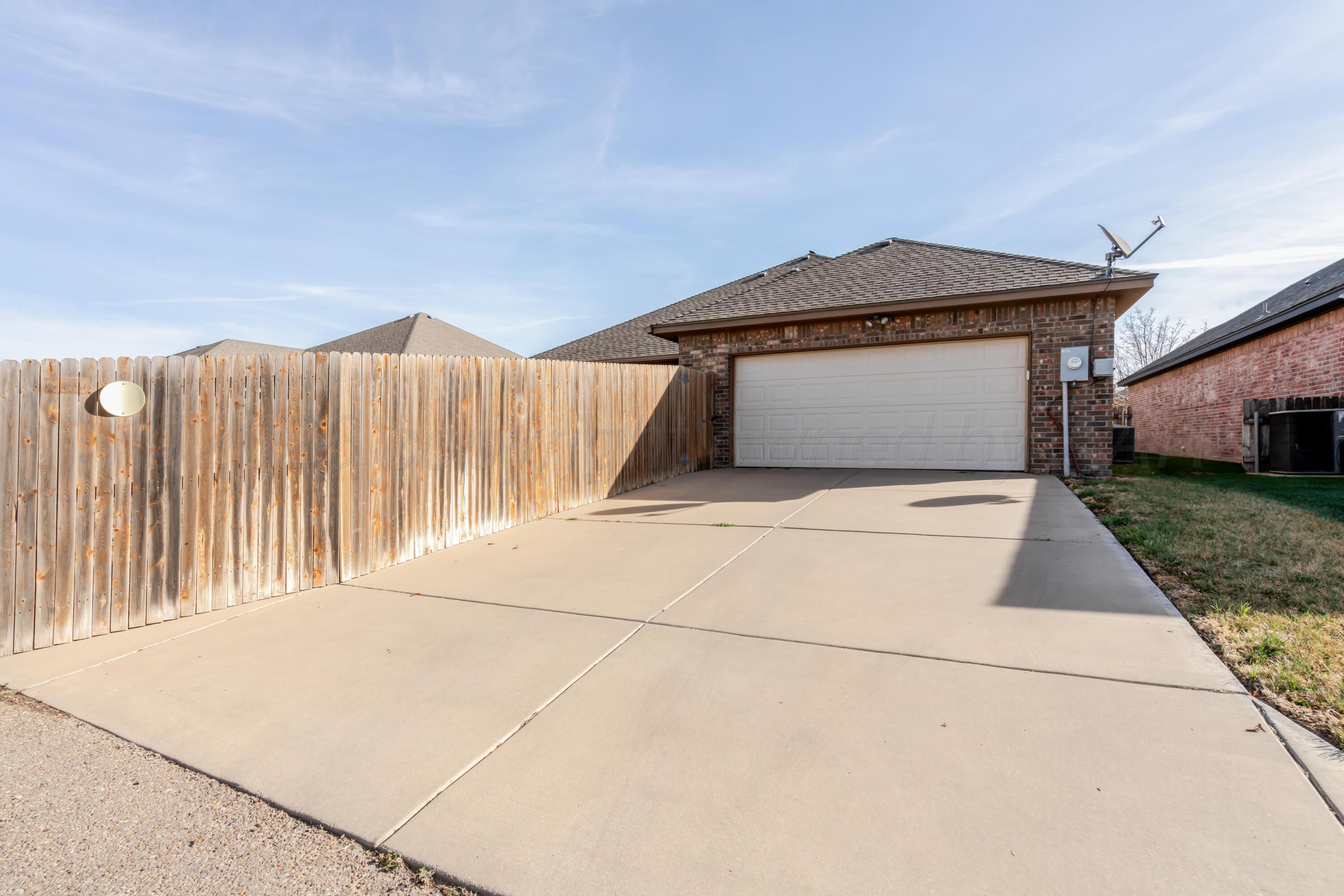 6814 Tivis Street Amarillo, TX 79119 - Photo 33 of 37 a front view of a house with garage