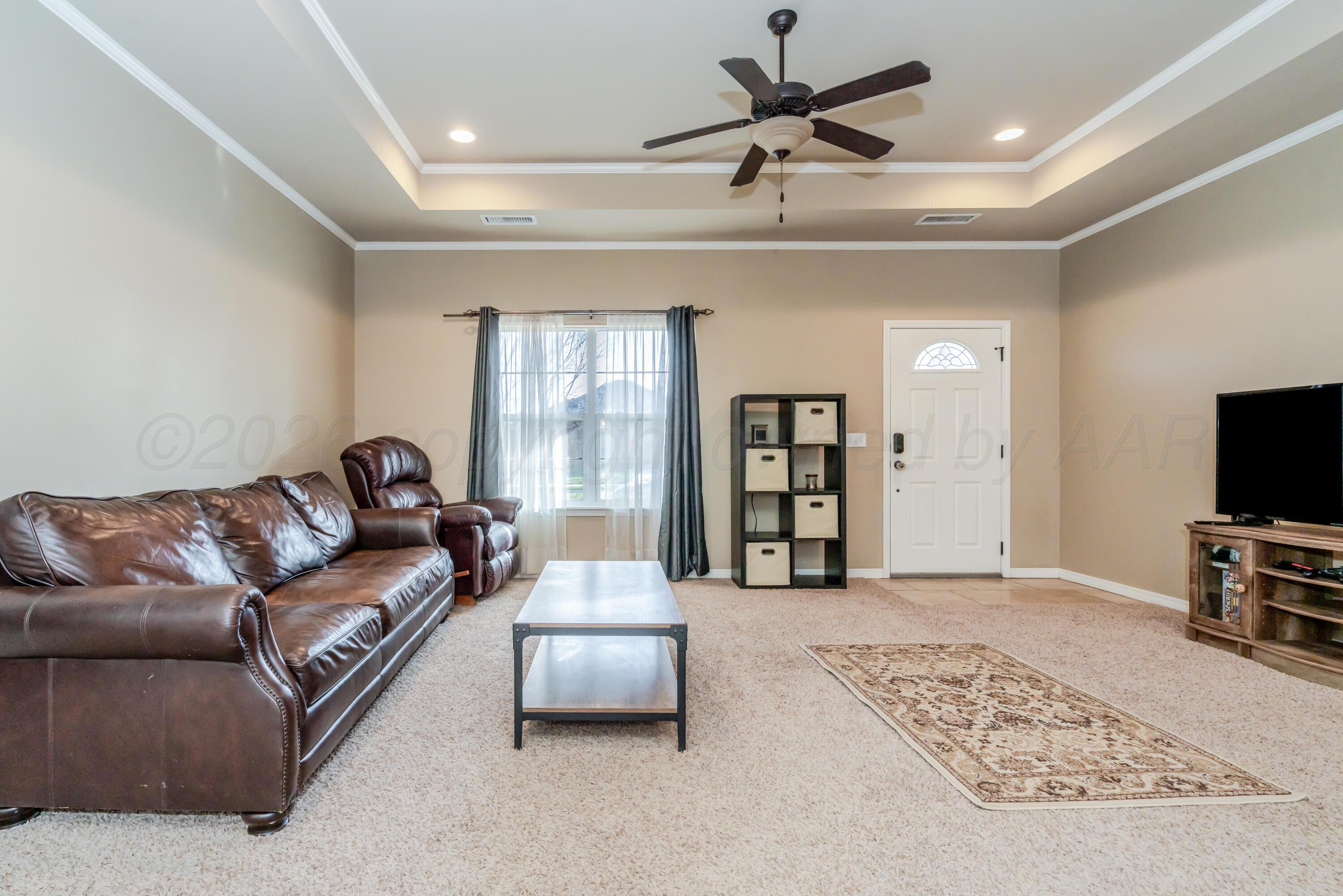 6814 Tivis Street Amarillo, TX 79119 - Photo 5 of 37 a living room with furniture and a flat screen tv