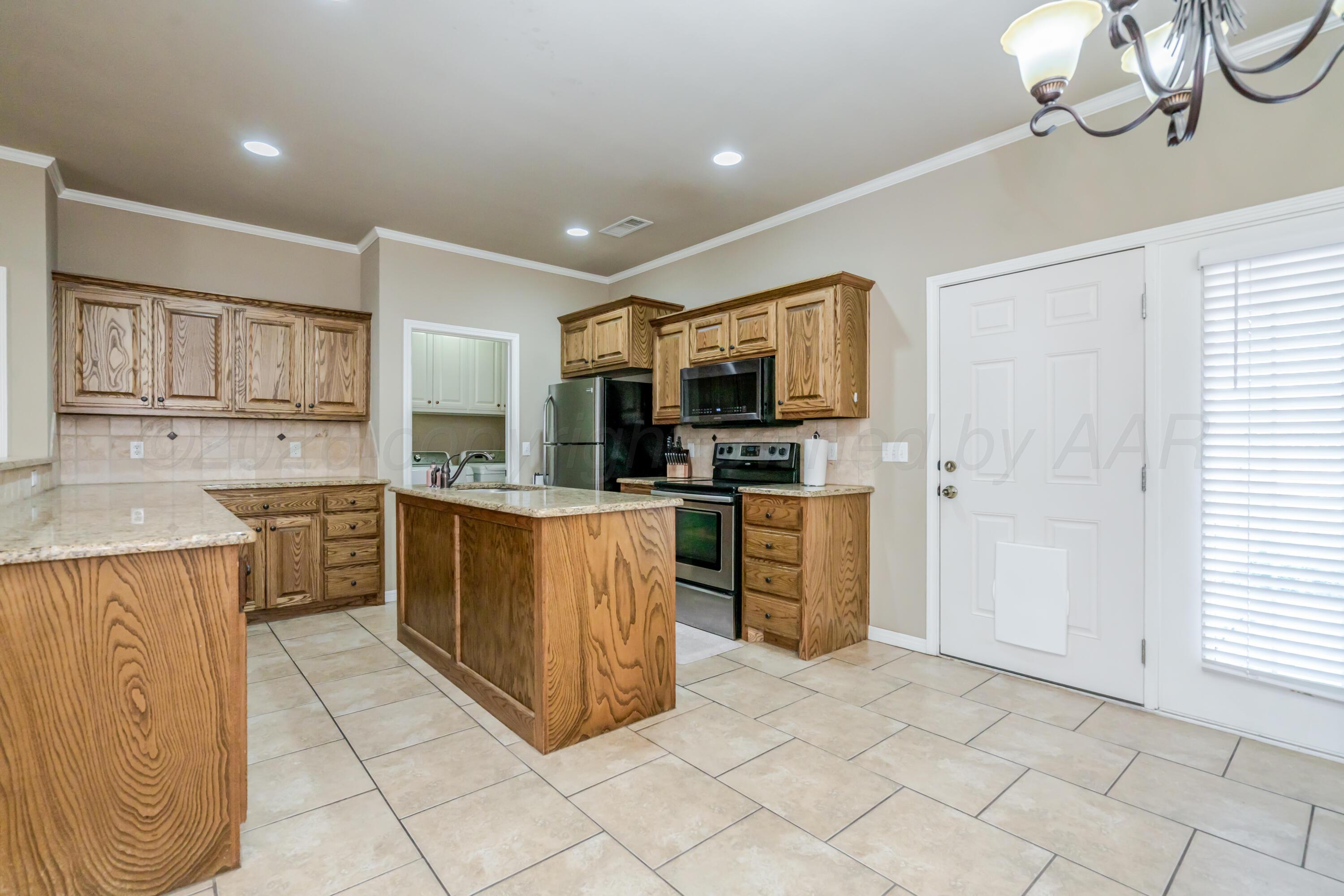 6814 Tivis Street Amarillo, TX 79119 - Photo 6 of 37 a kitchen with cabinets and stainless steel appliances
