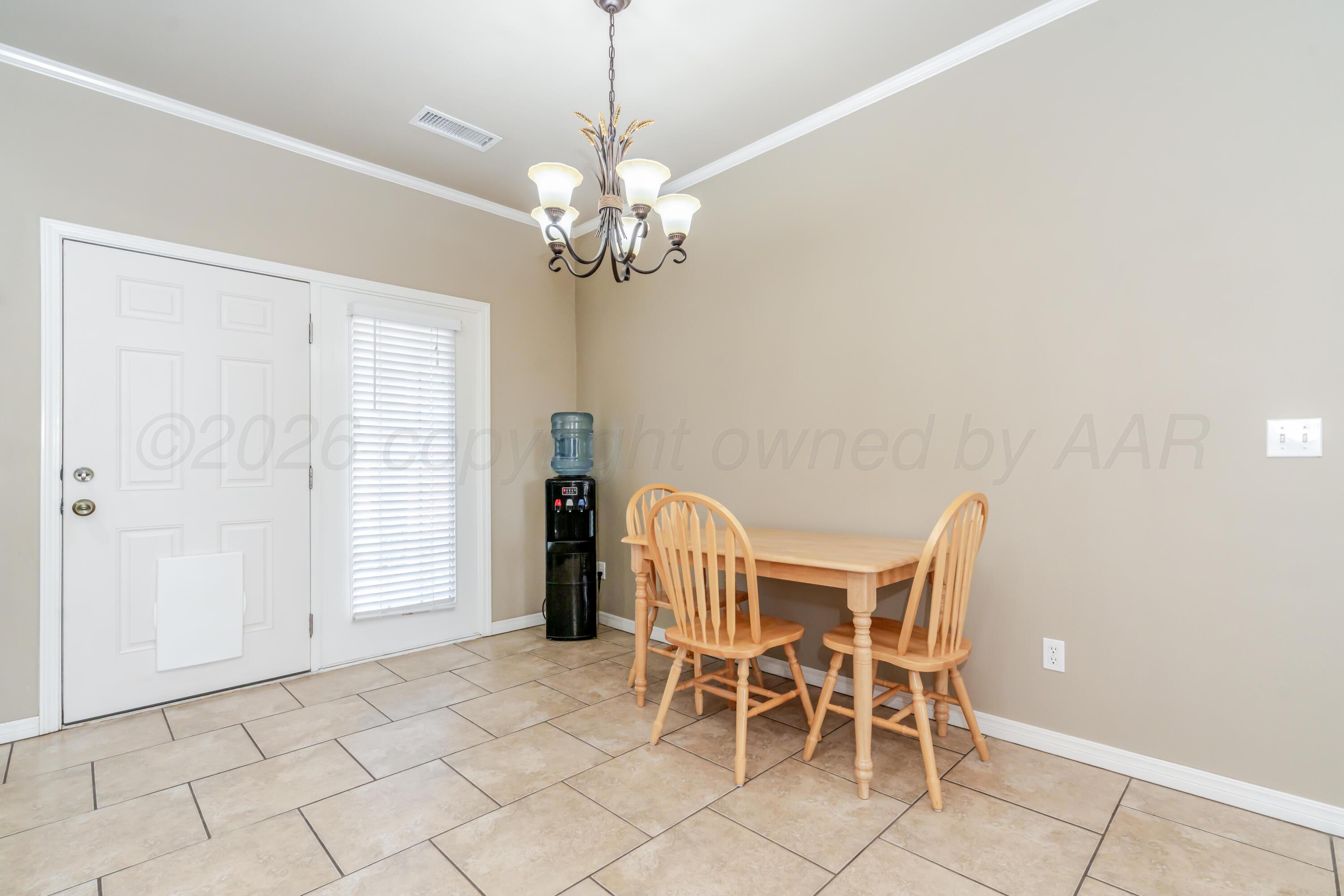 6814 Tivis Street Amarillo, TX 79119 - Photo 10 of 37 a view of a dining room with furniture and chandelier
