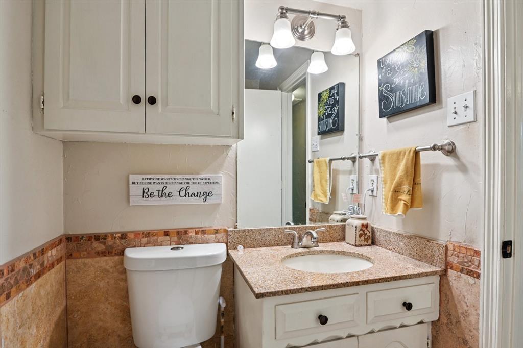 305 South Cockrell Hill Road Ovilla, TX 75154 - Photo 26 of 40 a bathroom with a granite countertop sink mirror and vanity