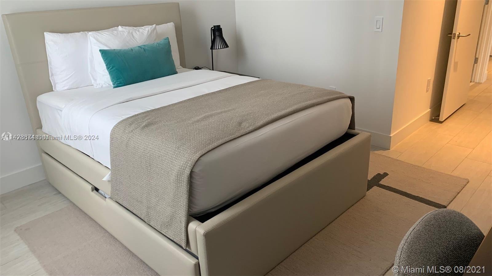 4010 South Ocean Drive, Unit R301 Hollywood, FL 33019 - Photo 3 of 18 a bed sitting in a bedroom next to a window