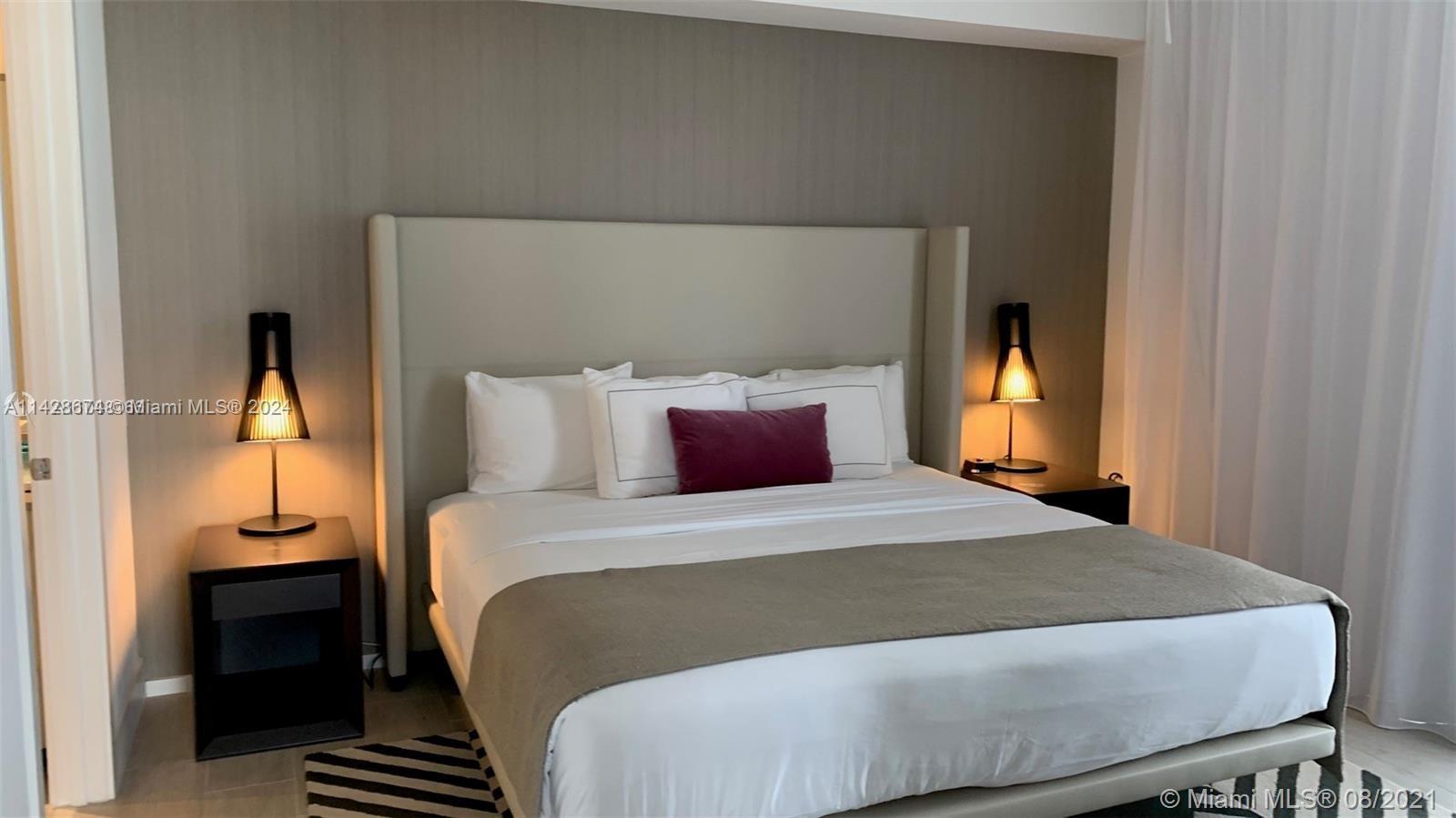 4010 South Ocean Drive, Unit R301 Hollywood, FL 33019 - Photo 8 of 18 a bedroom with a bed and wooden floor