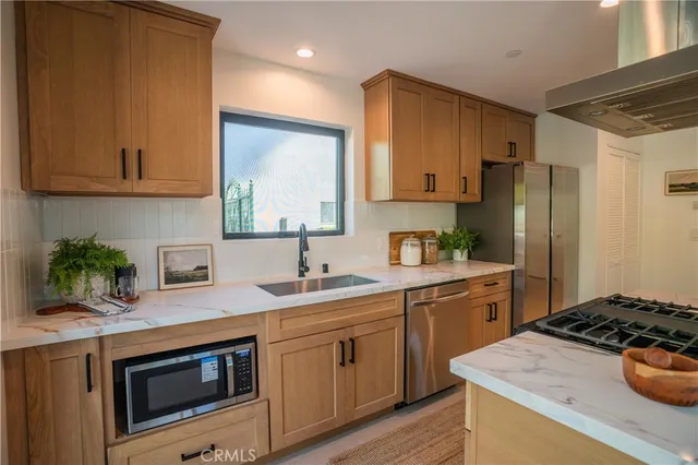 a living room with furniture large windows and wooden floor