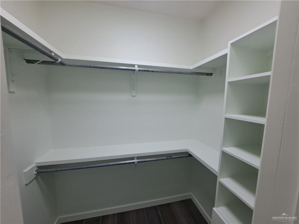 708 East 3rd Avenue Elsa, TX 78543 - Photo 21 of 33 Spacious closet featuring dark wood-style floors