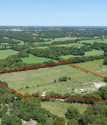 an aerial view of a houses with outdoor space and trees