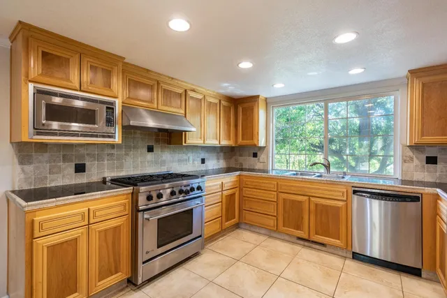 a view of a big room with windows and entryway