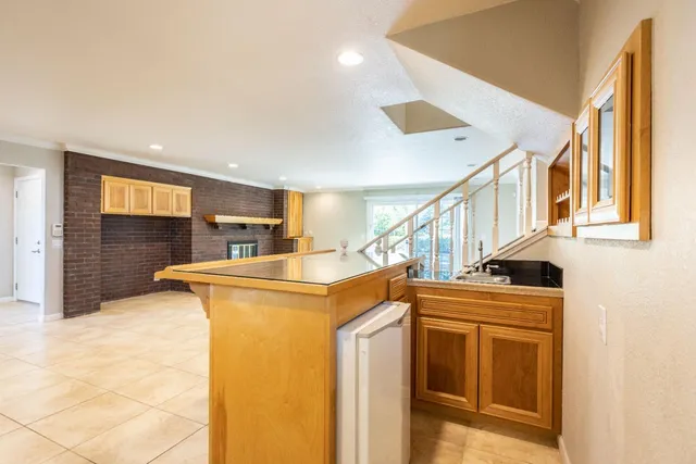 a kitchen with granite countertop white cabinets and a sink
