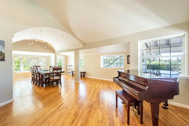 a view of a dining room with furniture and wooden floor