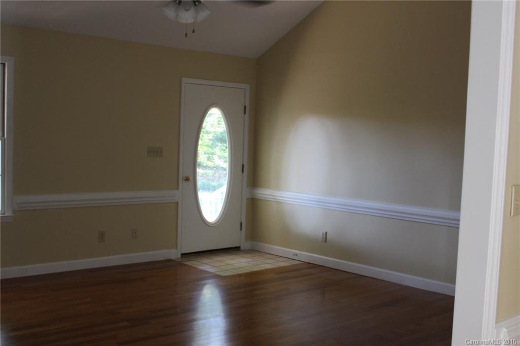 2205 New Salem Road Monroe, NC 28110 - Photo 11 of 18 an empty room with wooden floor and windows