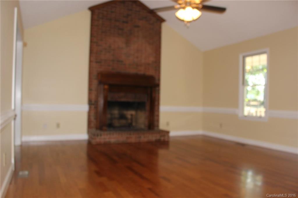 2205 New Salem Road Monroe, NC 28110 - Photo 12 of 18 a view of an empty room with window and wooden floor