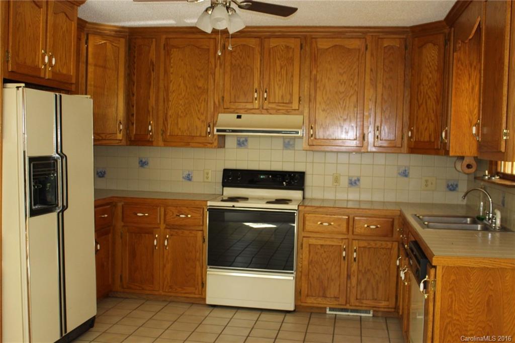 2205 New Salem Road Monroe, NC 28110 - Photo 15 of 18 a kitchen with a stove a sink and a refrigerator